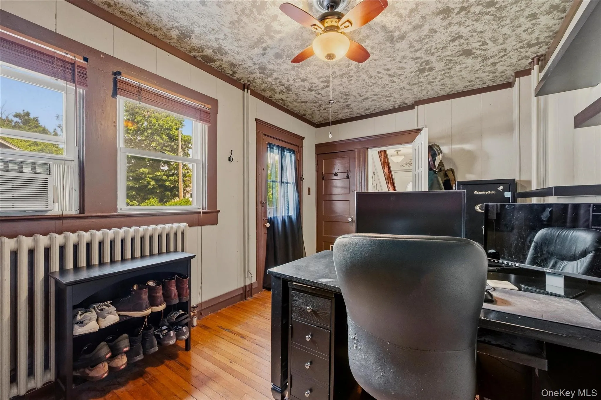 Hardwood flooring complements the neutral wall paneling Hardwood flooring complements the neutral wall paneling