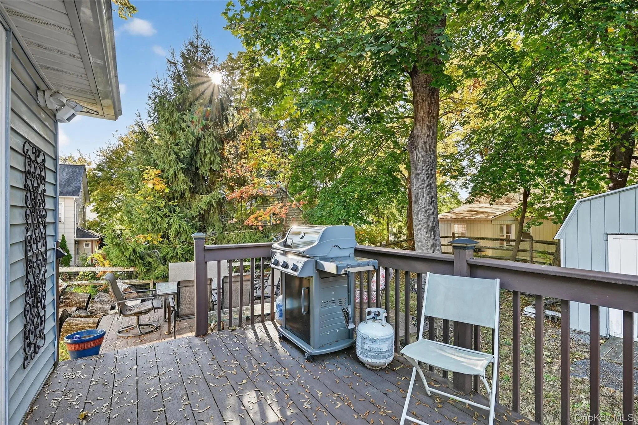 Expansive wood deck with dark-stained railings, offering ample space for outdoor seating and entertaining Expansive wood deck with dark-stained railings, offering ample space for outdoor seating and entertaining