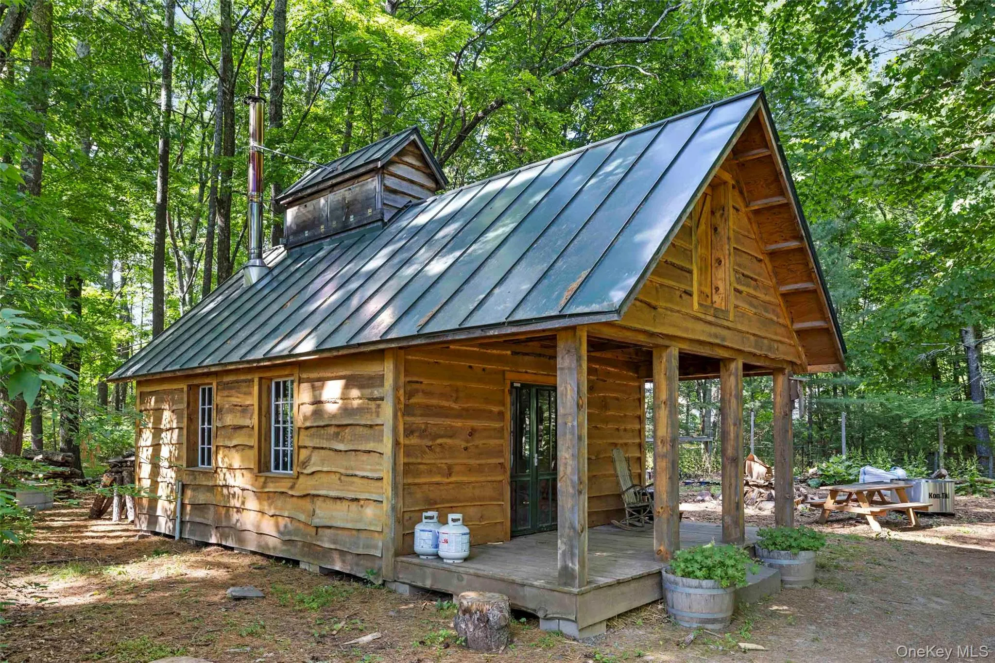 Traditional sugar shack nestled among the woodlands, supporting maple syrup production Traditional sugar shack nestled among the woodlands, supporting maple syrup production