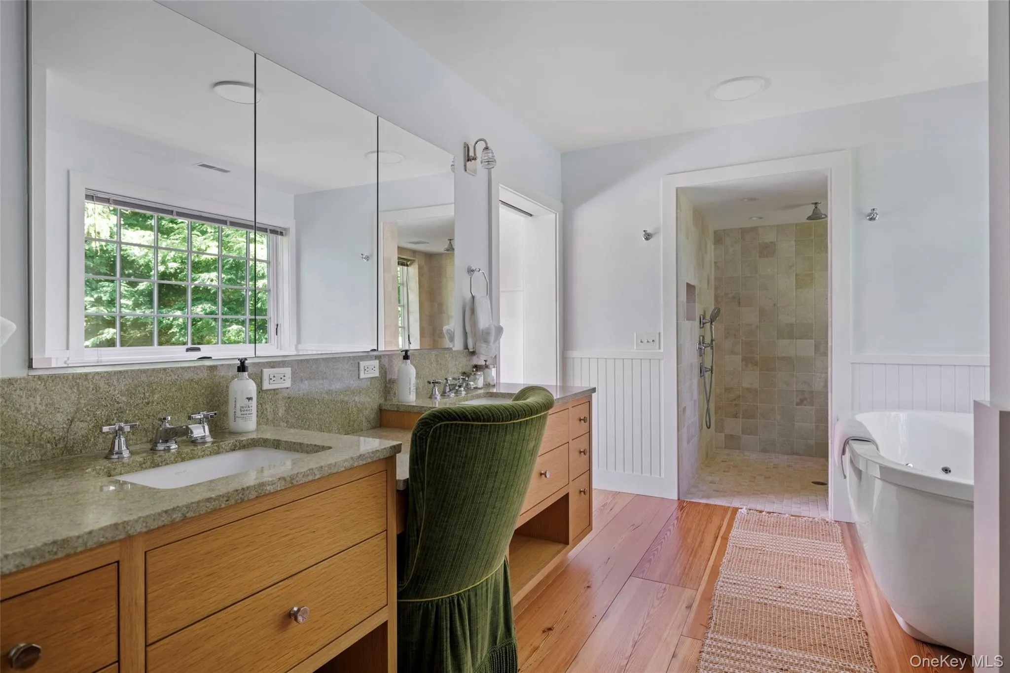 Spa-inspired bathroom with double vanity, oversized walk-in shower, and soaking tub with views over the gardens Spa-inspired bathroom with double vanity, oversized walk-in shower, and soaking tub with views over the gardens
