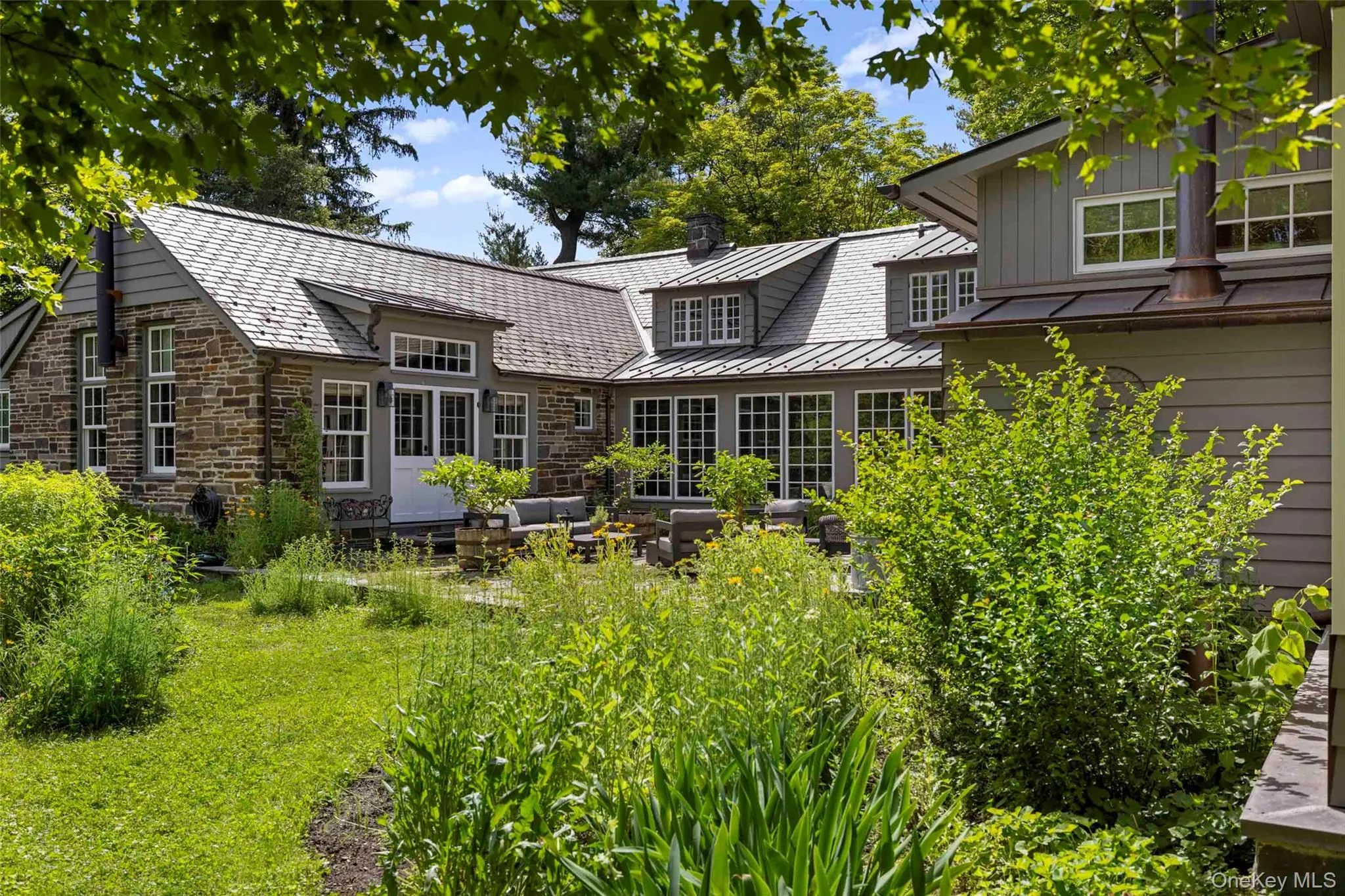 An inviting outdoor space with views across the surrounding gardens, thoughtfully positioned between the home’s east and west wings An inviting outdoor space with views across the surrounding gardens, thoughtfully positioned between the home’s east and west wings