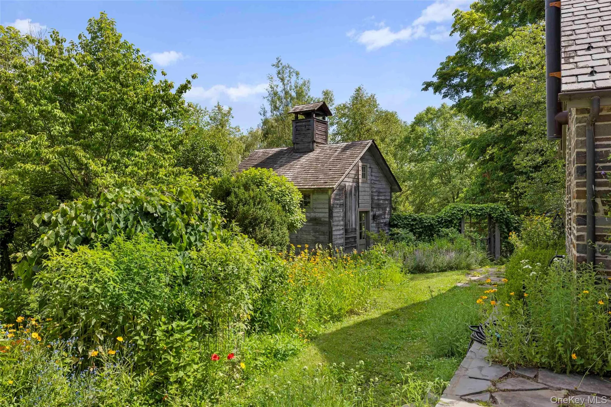 A tranquil garden setting surrounds the wellness studio, creating a peaceful connection with nature A tranquil garden setting surrounds the wellness studio, creating a peaceful connection with nature