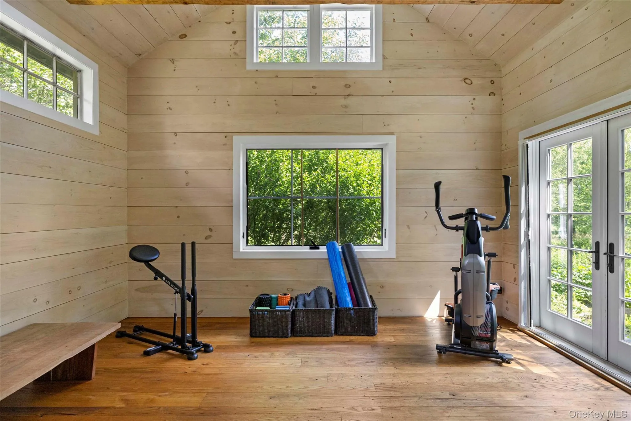 Light-filled wellness studio with vaulted ceilings and French doors opening to the gardens, ideal for yoga, meditation, fitness, or creative pursuits Light-filled wellness studio with vaulted ceilings and French doors opening to the gardens, ideal for yoga, meditation, fitness, or creative pursuits