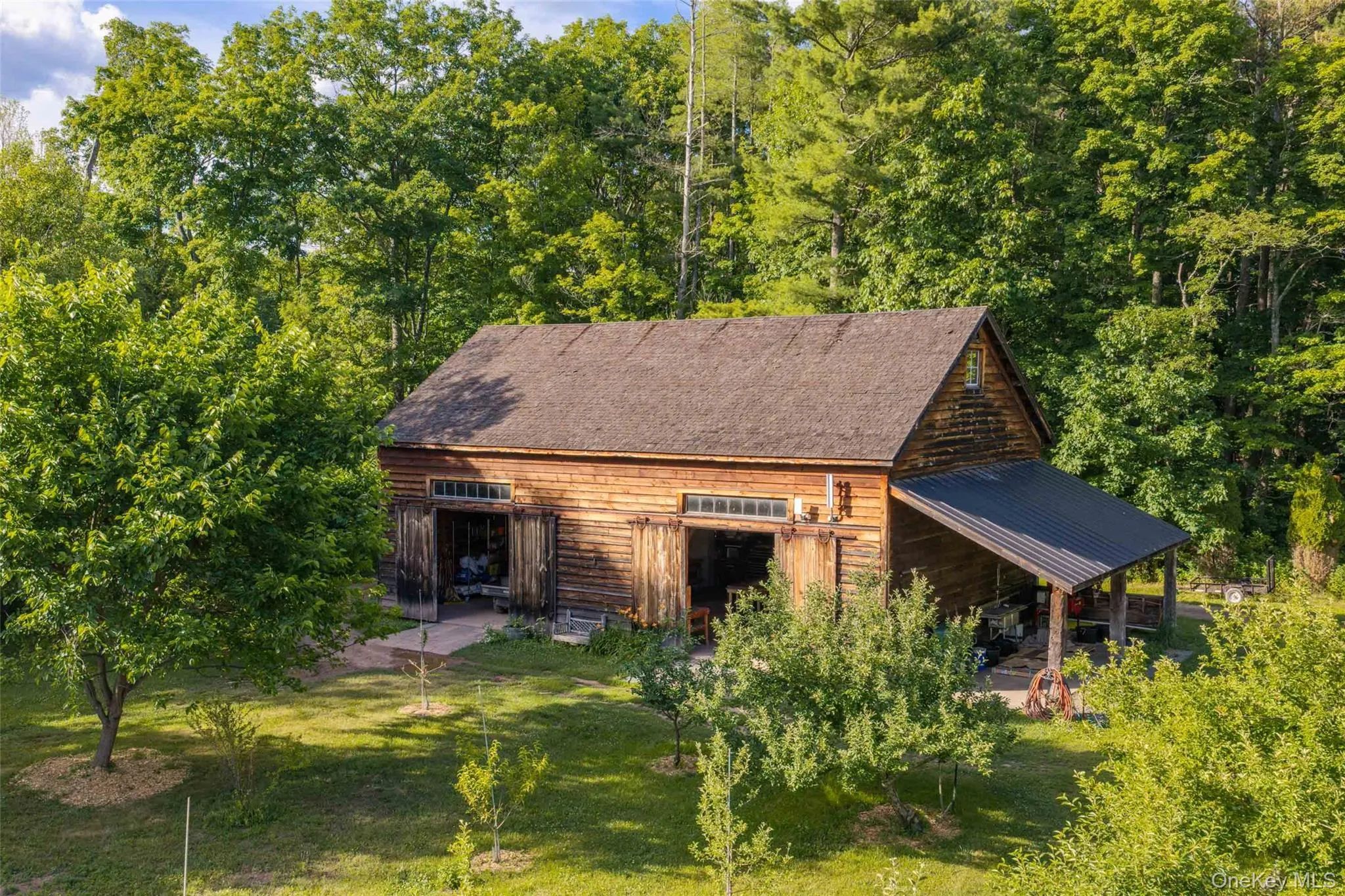 A beautifully restored 19th-century timber-frame barn, relocated from Cairo, New York, supporting the estate’s agricultural and horticultural operations A beautifully restored 19th-century timber-frame barn, relocated from Cairo, New York, supporting the estate’s agricultural and horticultural operations