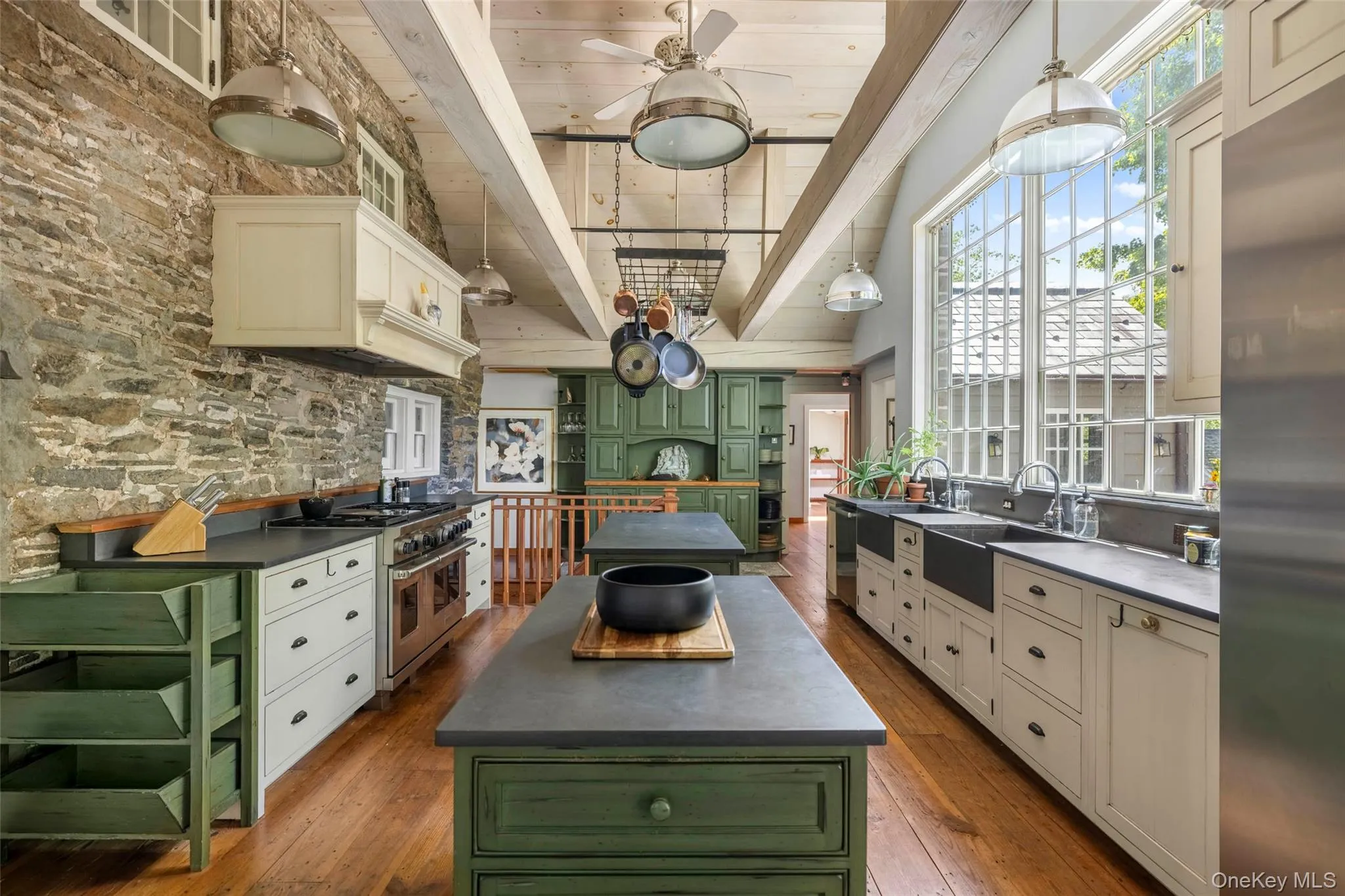 Soaring ceilings and oversized windows with views over the gardens fill the kitchen with natural light Soaring ceilings and oversized windows with views over the gardens fill the kitchen with natural light