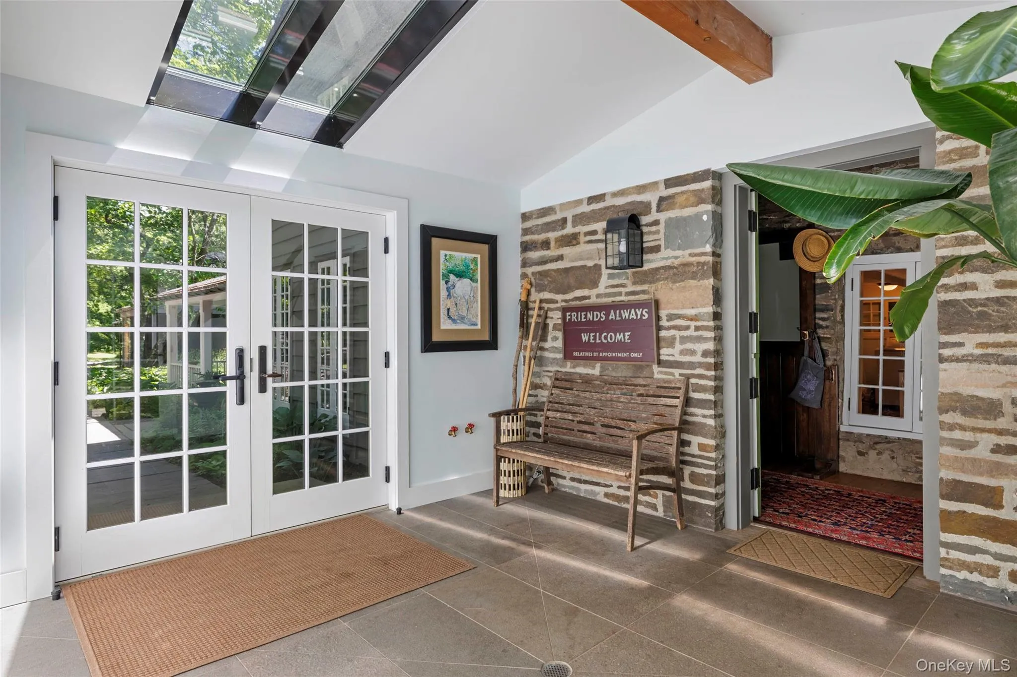 Welcoming foyer with skylights and original stone walls Welcoming foyer with skylights and original stone walls