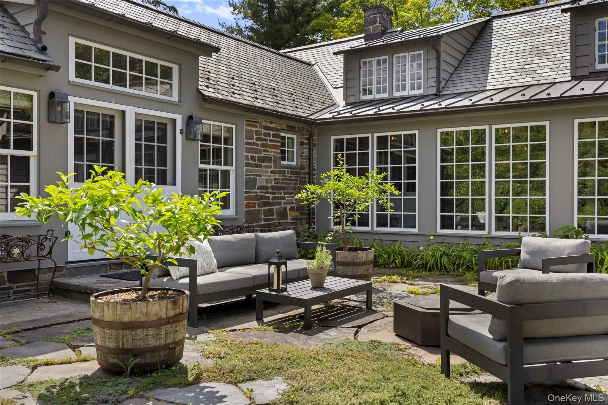 A beautifully landscaped stone courtyard, offering a secluded outdoor setting for entertaining and quiet relaxation A beautifully landscaped stone courtyard, offering a secluded outdoor setting for entertaining and quiet relaxation