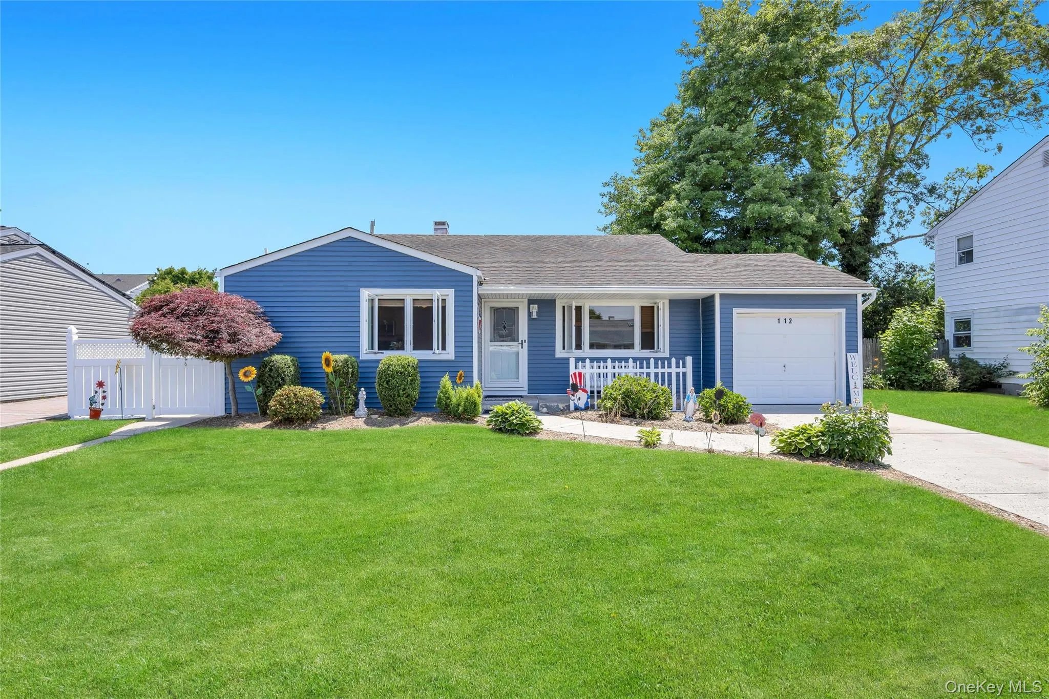 Split Level residence featuring blue siding and a white trim Split Level residence featuring blue siding and a white trim