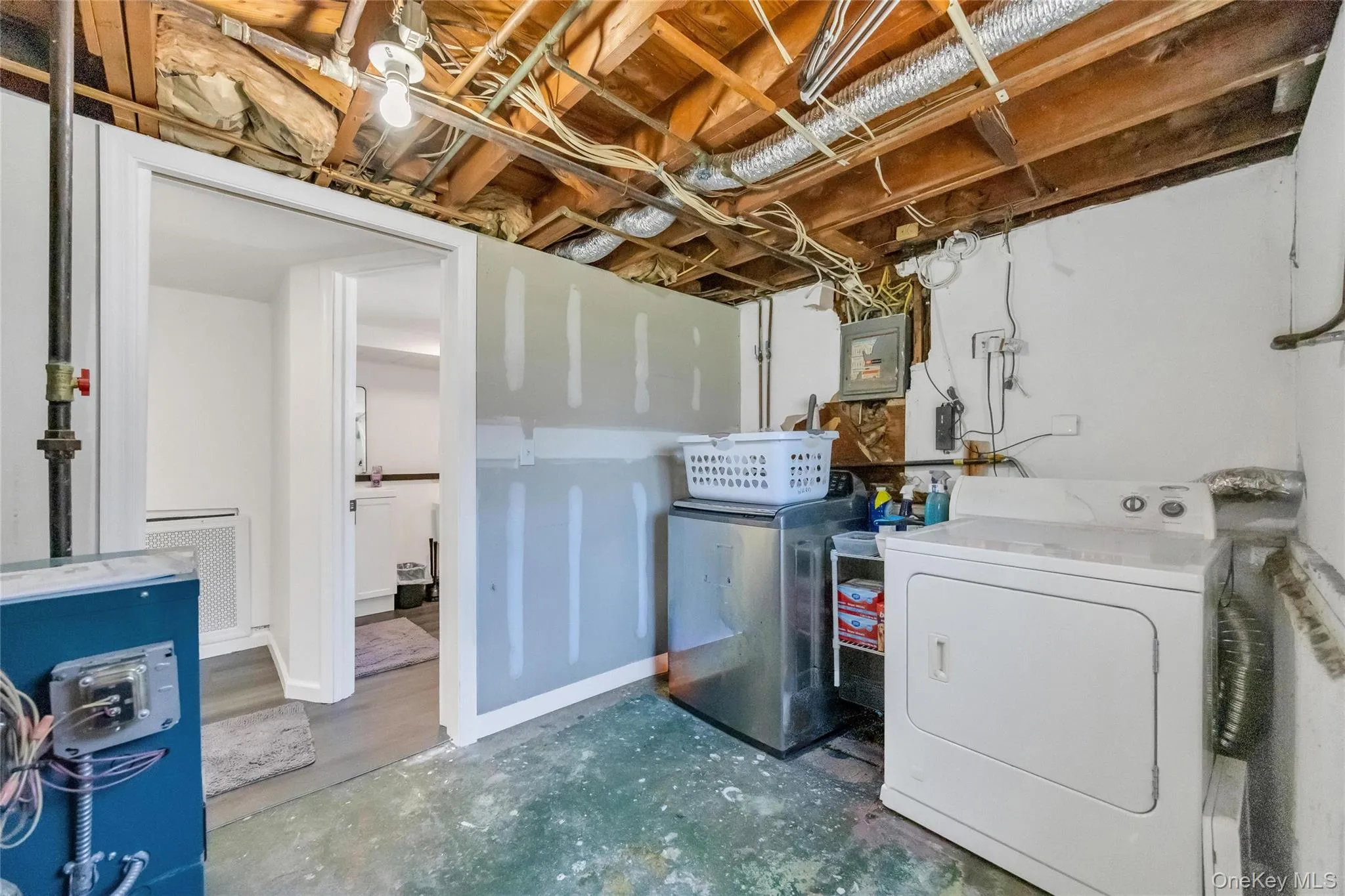Utility area with exposed ceiling joists, ductwork, and electrical wiring Utility area with exposed ceiling joists, ductwork, and electrical wiring
