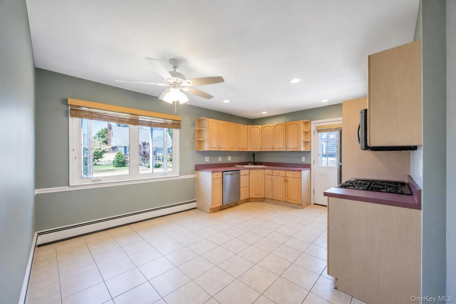 Kitchen space featuring light wood cabinetry and a gas range Kitchen space featuring light wood cabinetry and a gas range