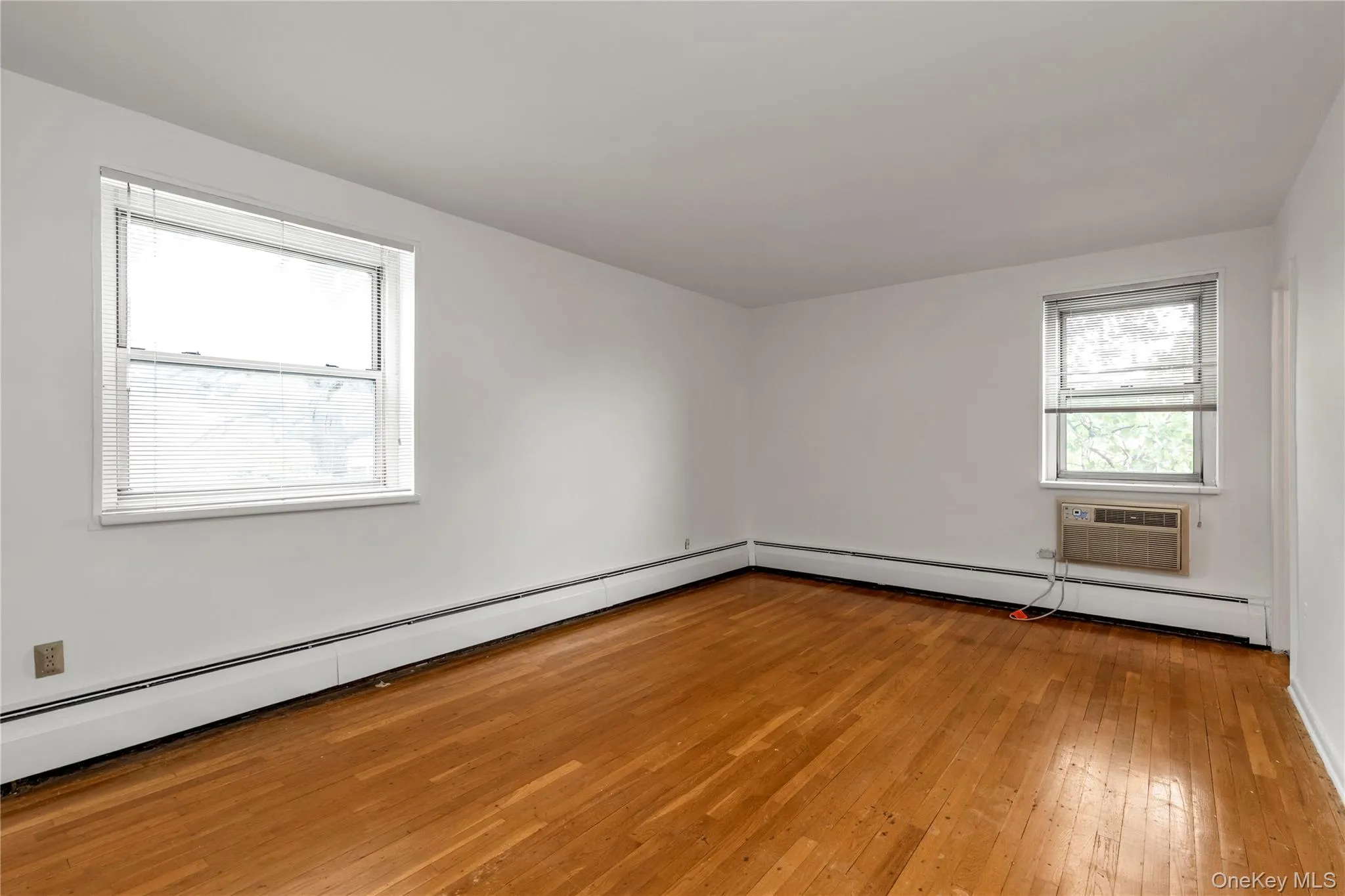 Primary Bedroom with Hardwood Floors Primary Bedroom with Hardwood Floors