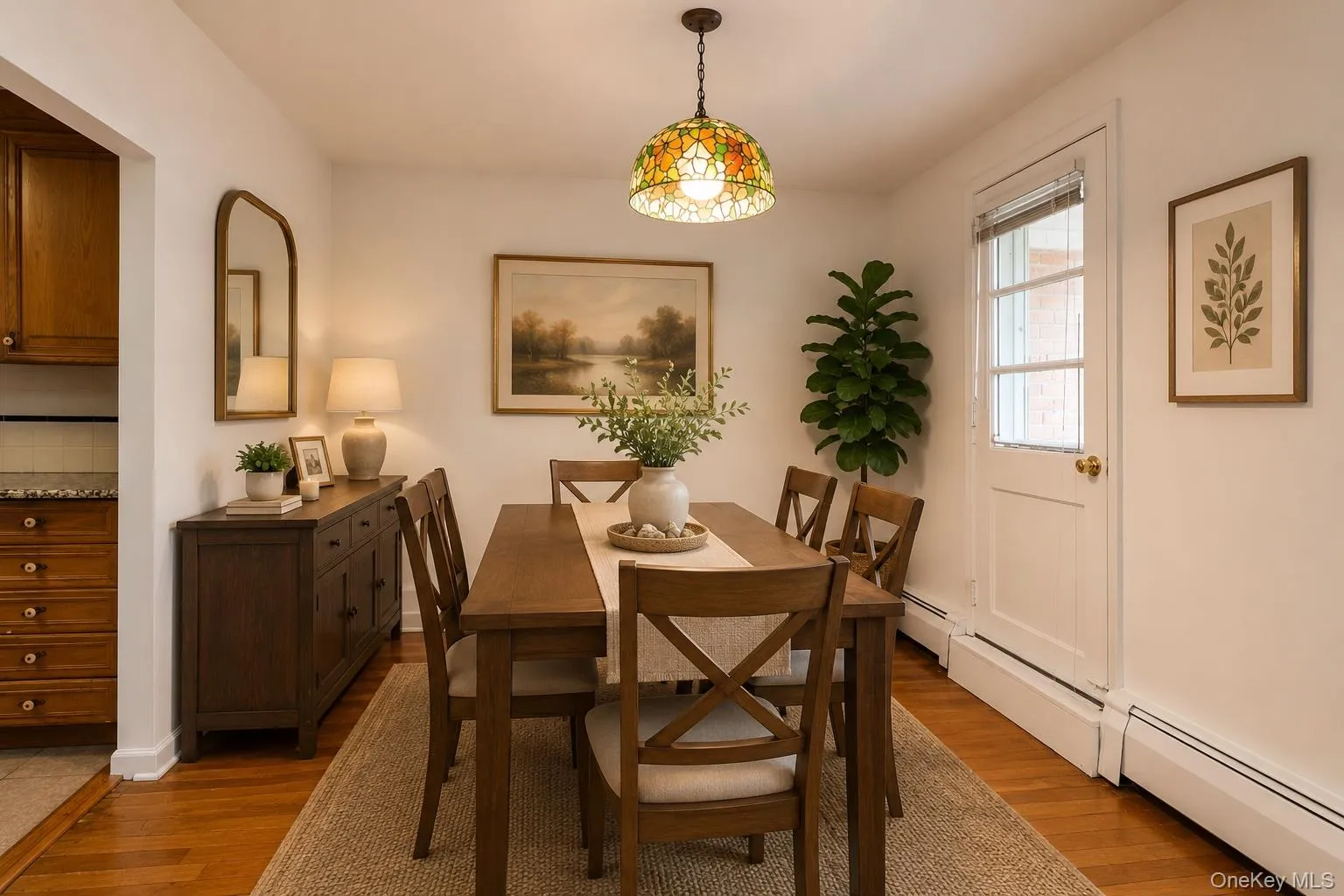 Virtually Staged Dining Area with Hardwood Floors & Door to Balcony Virtually Staged Dining Area with Hardwood Floors & Door to Balcony