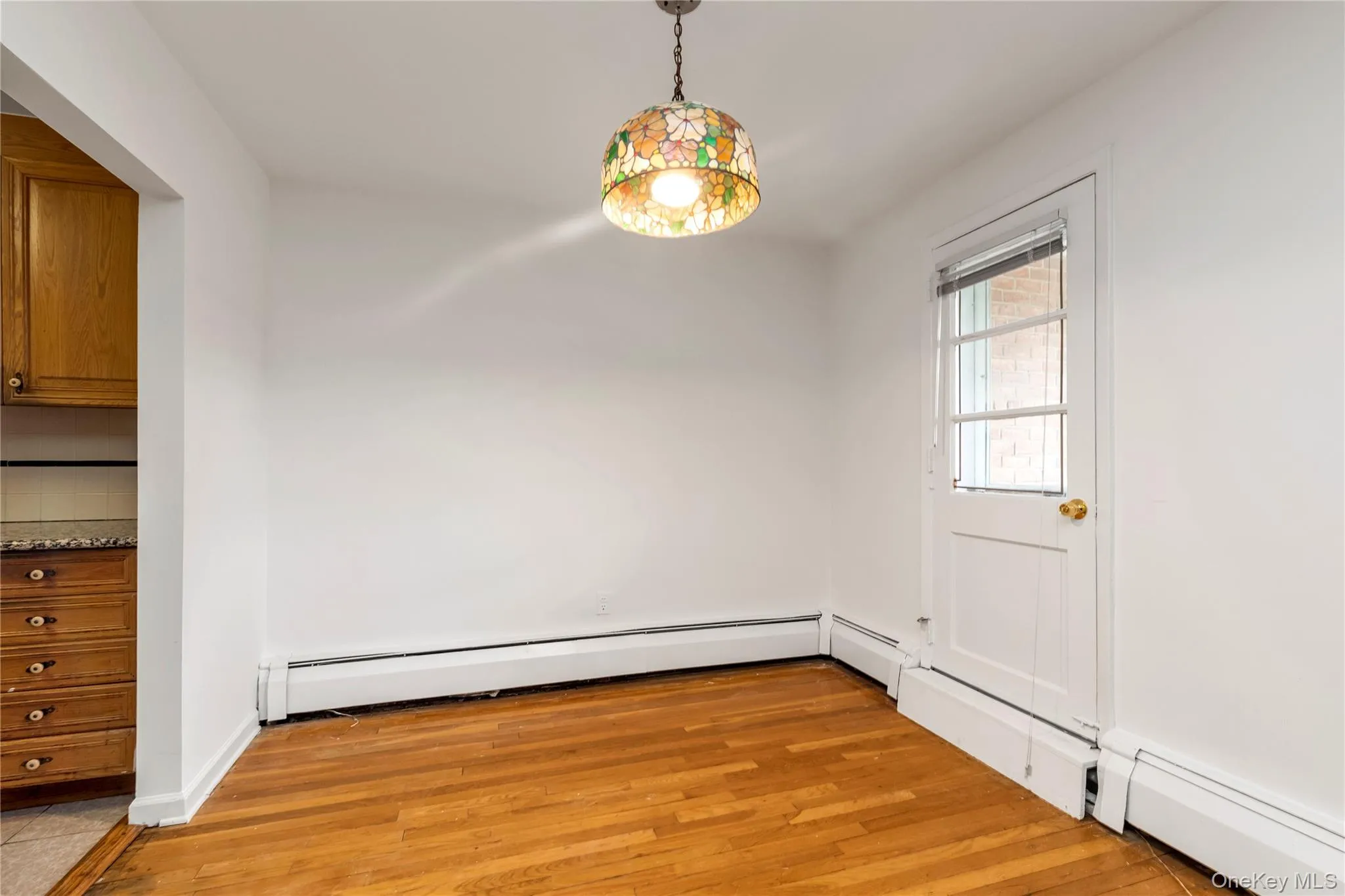 Dining Area with Hardwood Floors & Door to Balcony Dining Area with Hardwood Floors & Door to Balcony