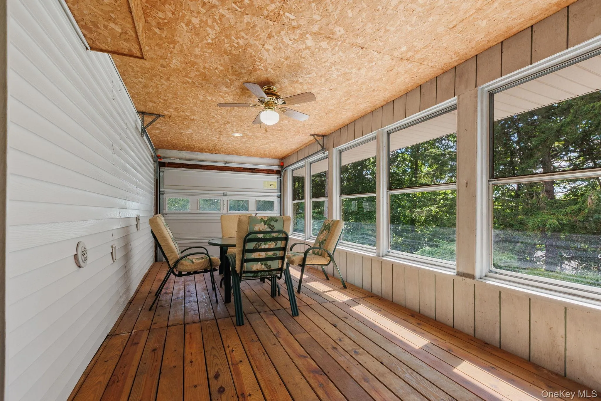 Sun room featured hardwood floors throughout, lots of windows and a garage door for a retro experience. Sun room featured hardwood floors throughout, lots of windows and a garage door for a retro experience.