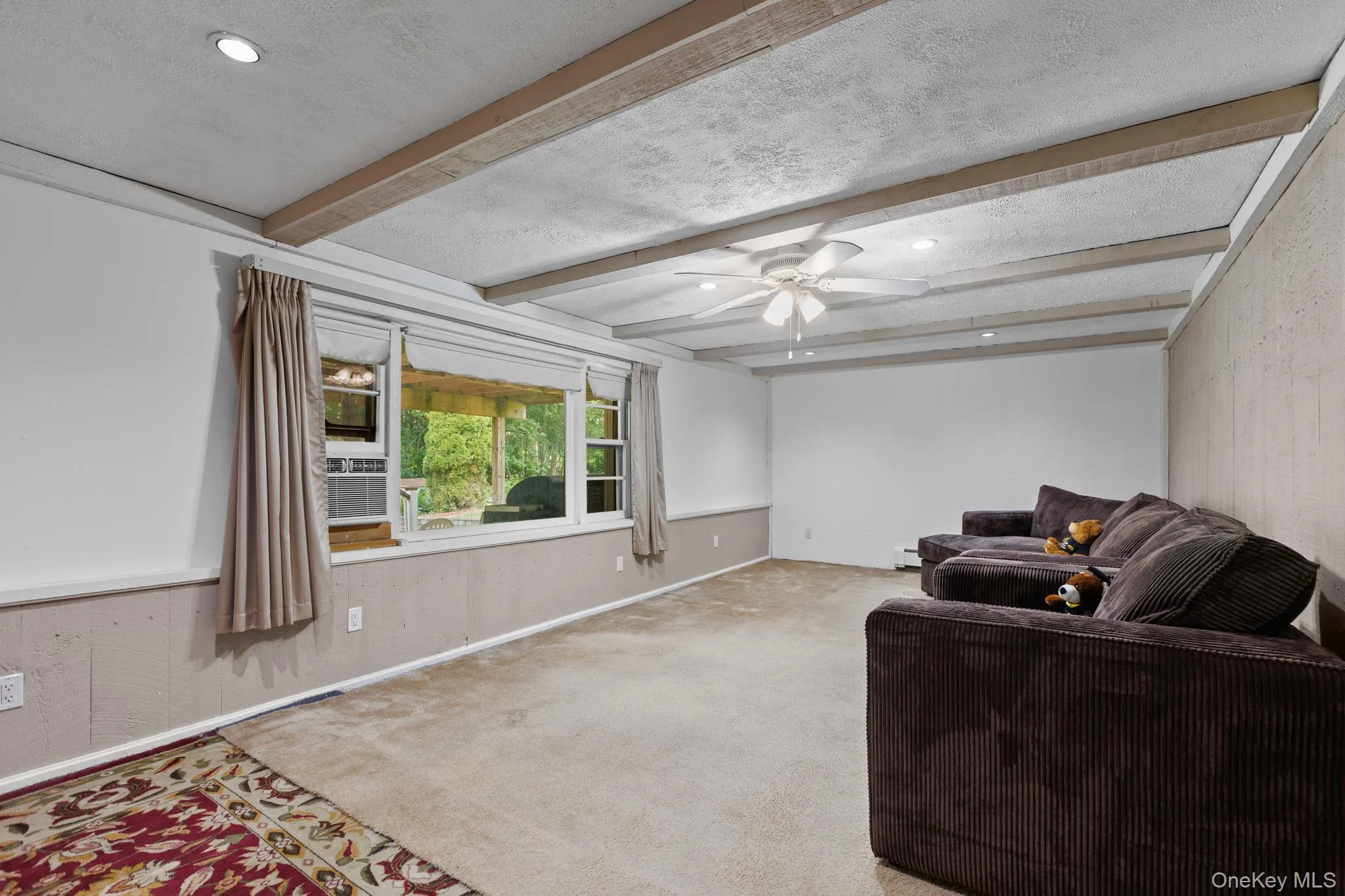 Spacious finished basement with view of the patio and backyard. Spacious finished basement with view of the patio and backyard.