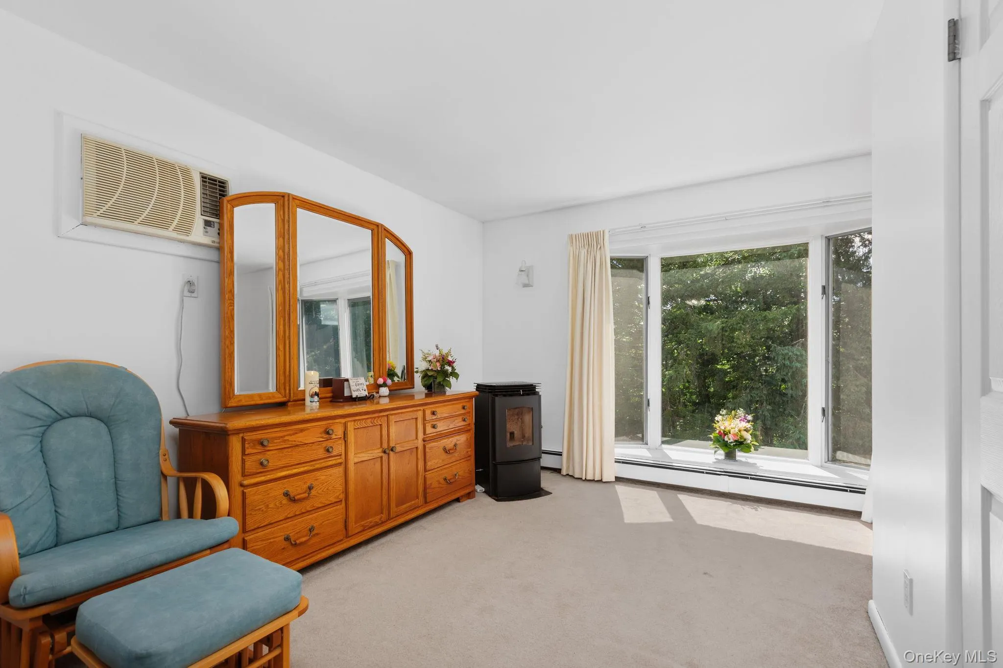 Sitting room area of the primary suite with a bay window that allows you to enjoy a panoramic outdoor view in the comfort of your own home. Sitting room area of the primary suite with a bay window that allows you to enjoy a panoramic outdoor view in the comfort of your own home.