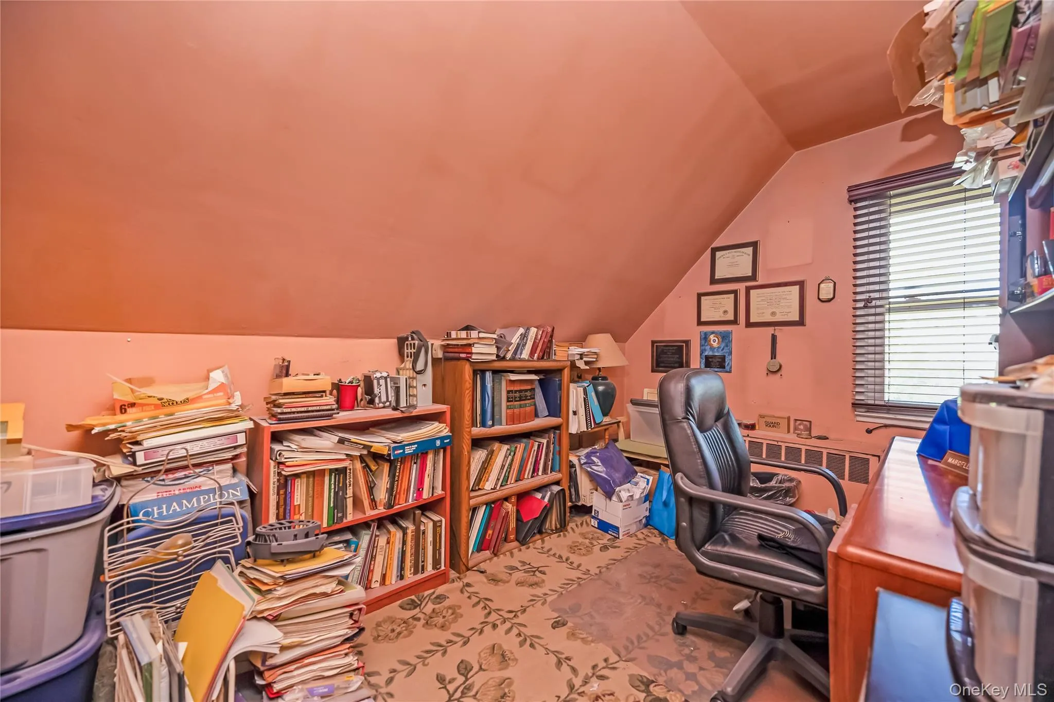 Room featuring sloped ceilings and a window with horizontal blinds Room featuring sloped ceilings and a window with horizontal blinds