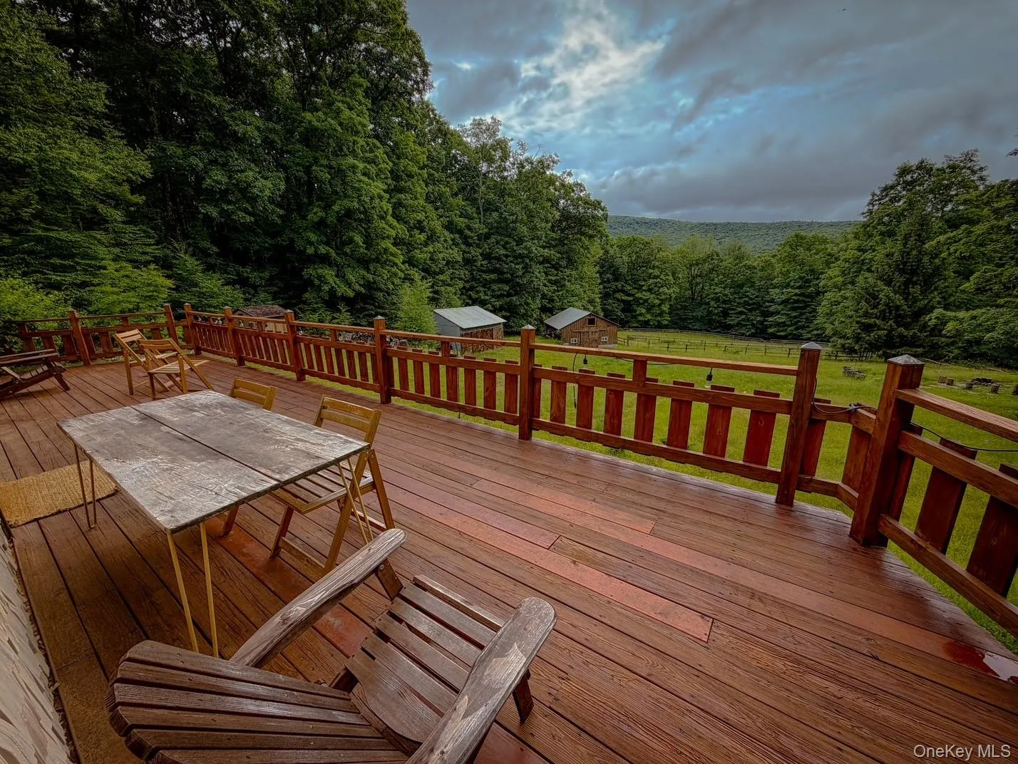 Expansive wood-finish deck with a wood railing system Expansive wood-finish deck with a wood railing system