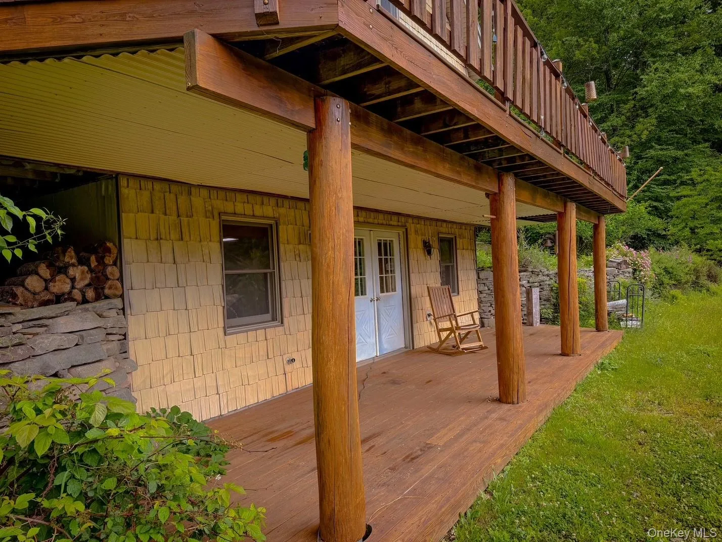 Expansive wood deck with natural wood support posts Expansive wood deck with natural wood support posts