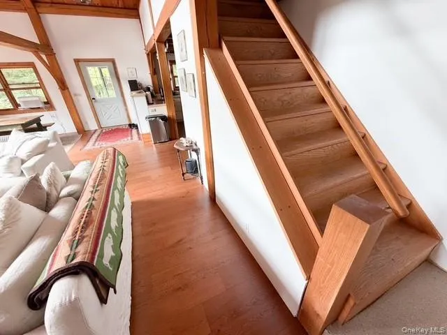 Light wood-finish staircase with matching banister and an open tread design Light wood-finish staircase with matching banister and an open tread design