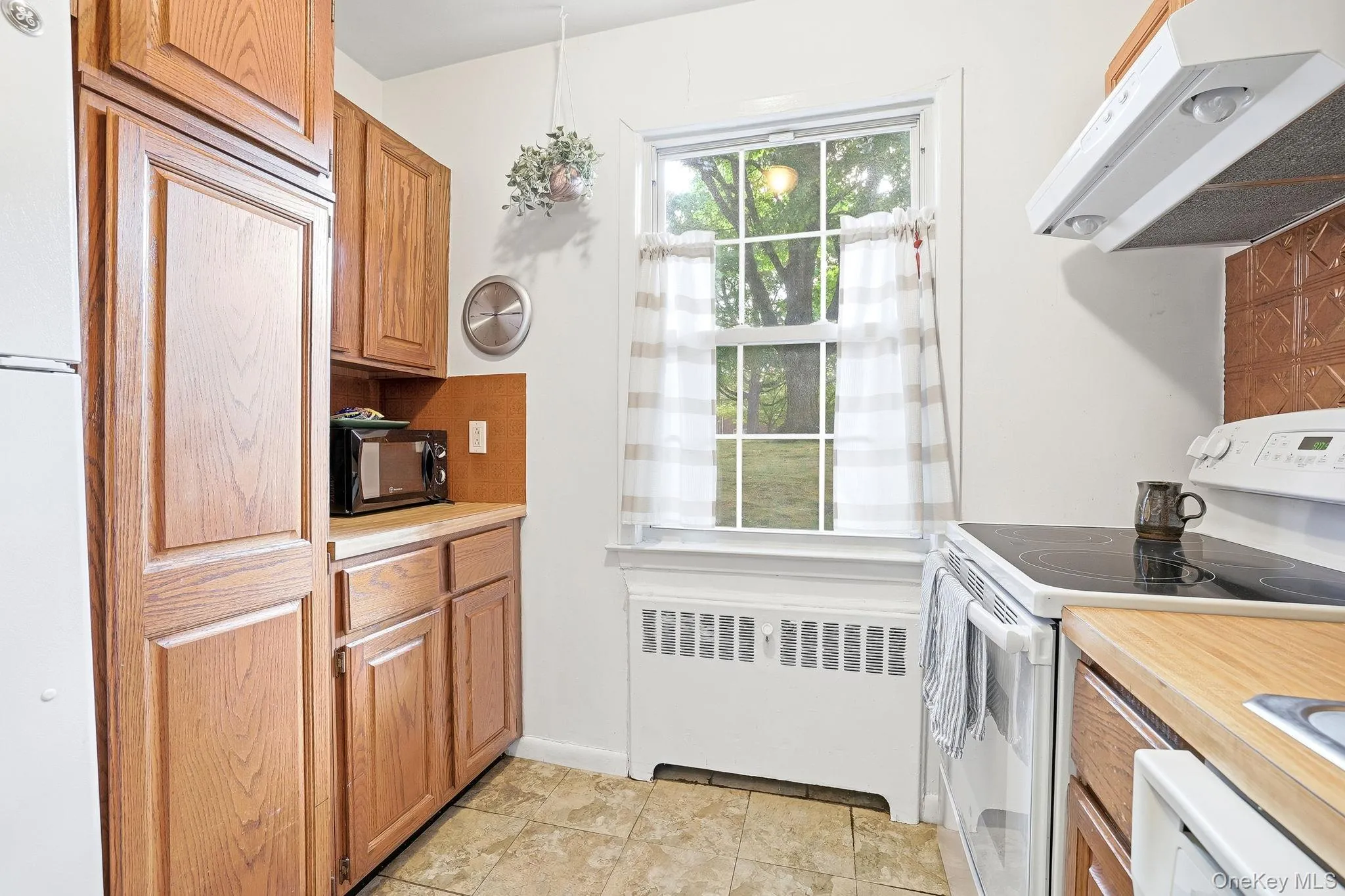 This renovated kitchen has beautiful oak cabinetry and two countertops for your work space This renovated kitchen has beautiful oak cabinetry and two countertops for your work space