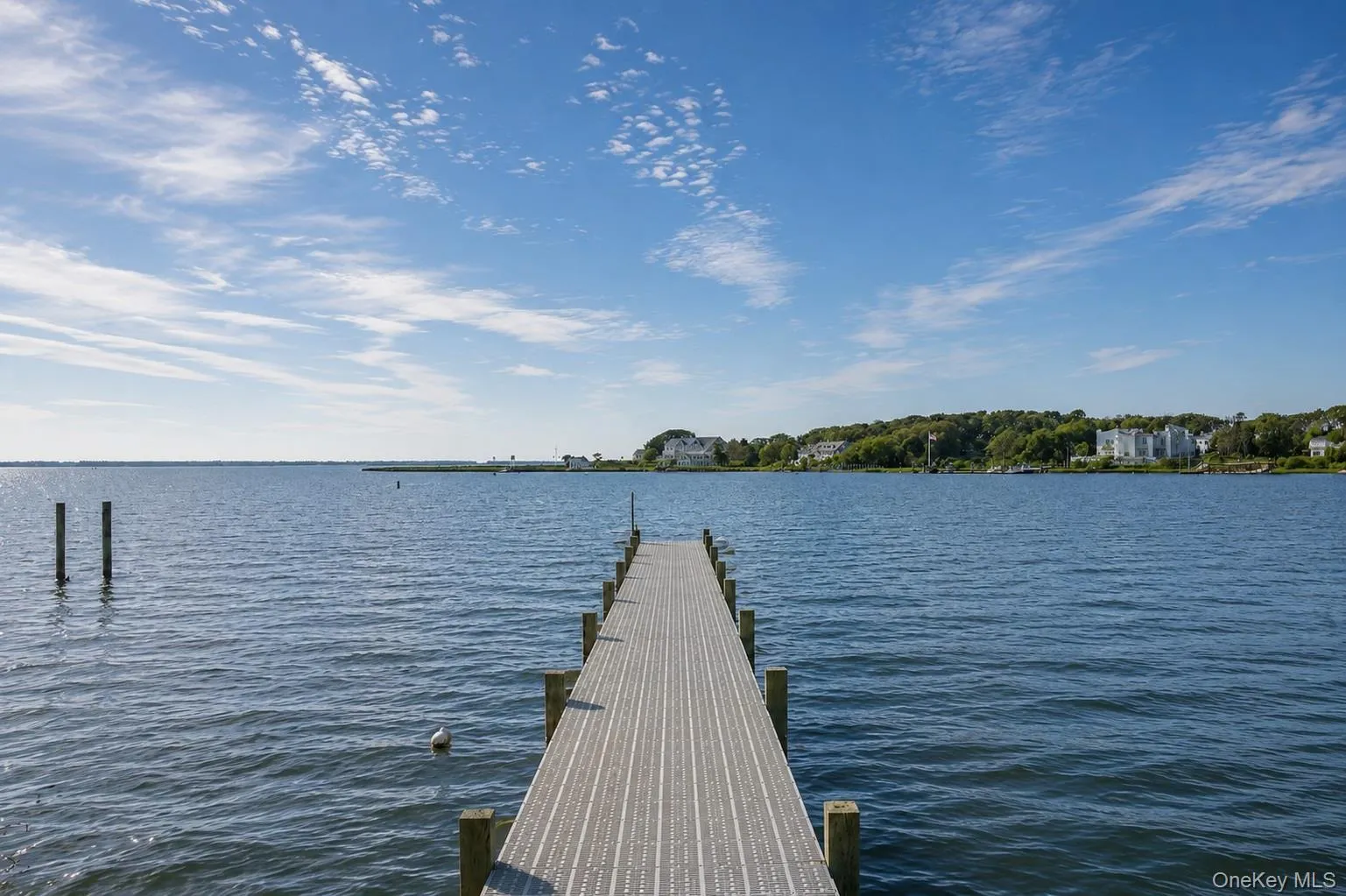Private dock extending over expansive open water Private dock extending over expansive open water