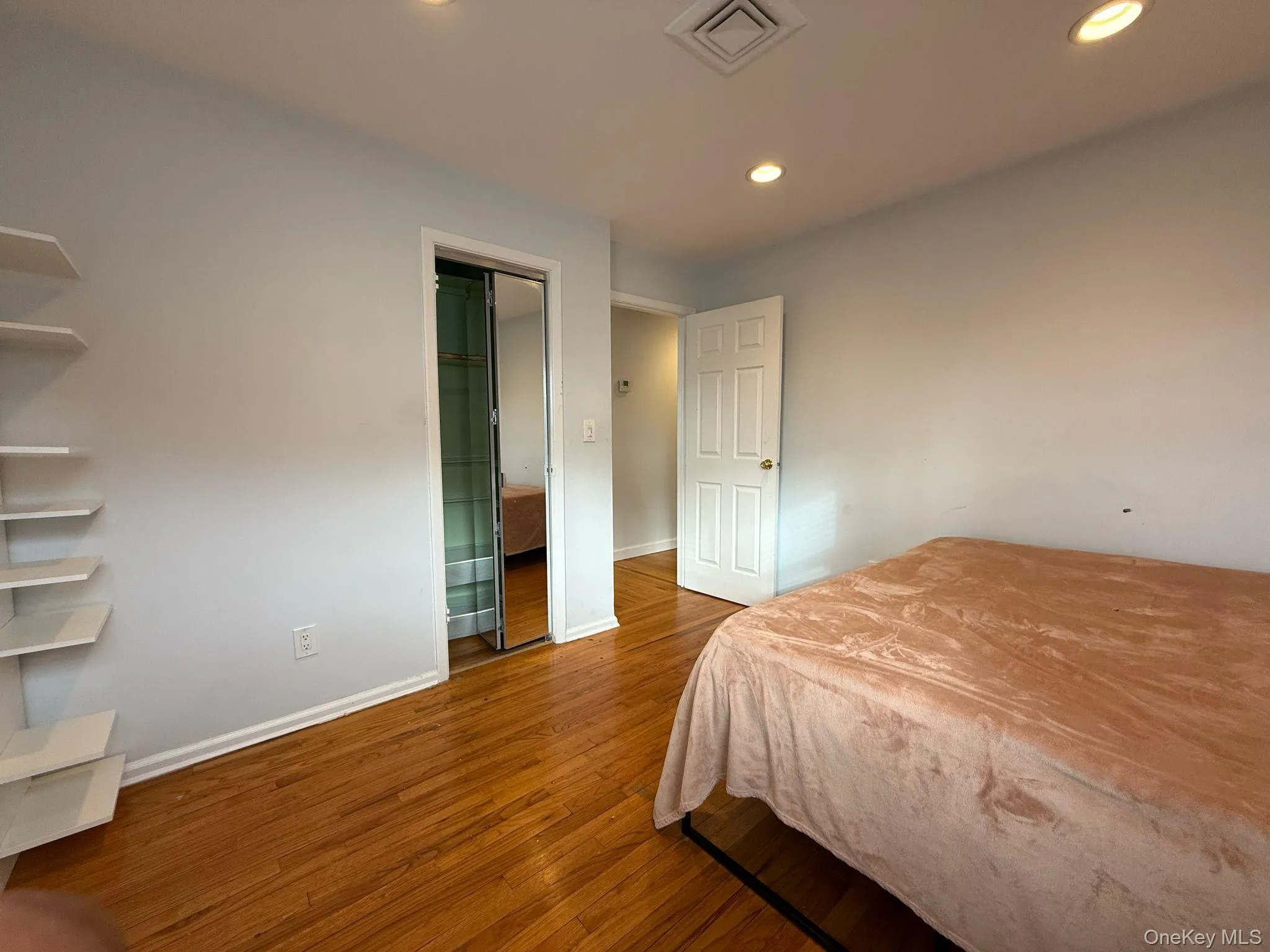 Bedroom with baseboards, visible vents, wood finished floors, and recessed lighting Bedroom with baseboards, visible vents, wood finished floors, and recessed lighting