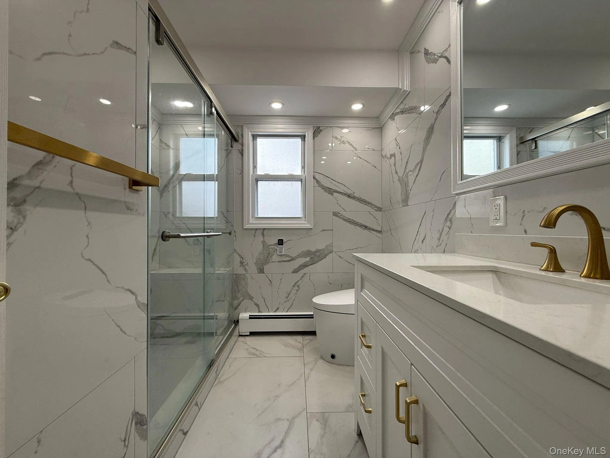 Full bath with marble finish floor, stone wall, a marble finish shower, and a baseboard radiator Full bath with marble finish floor, stone wall, a marble finish shower, and a baseboard radiator