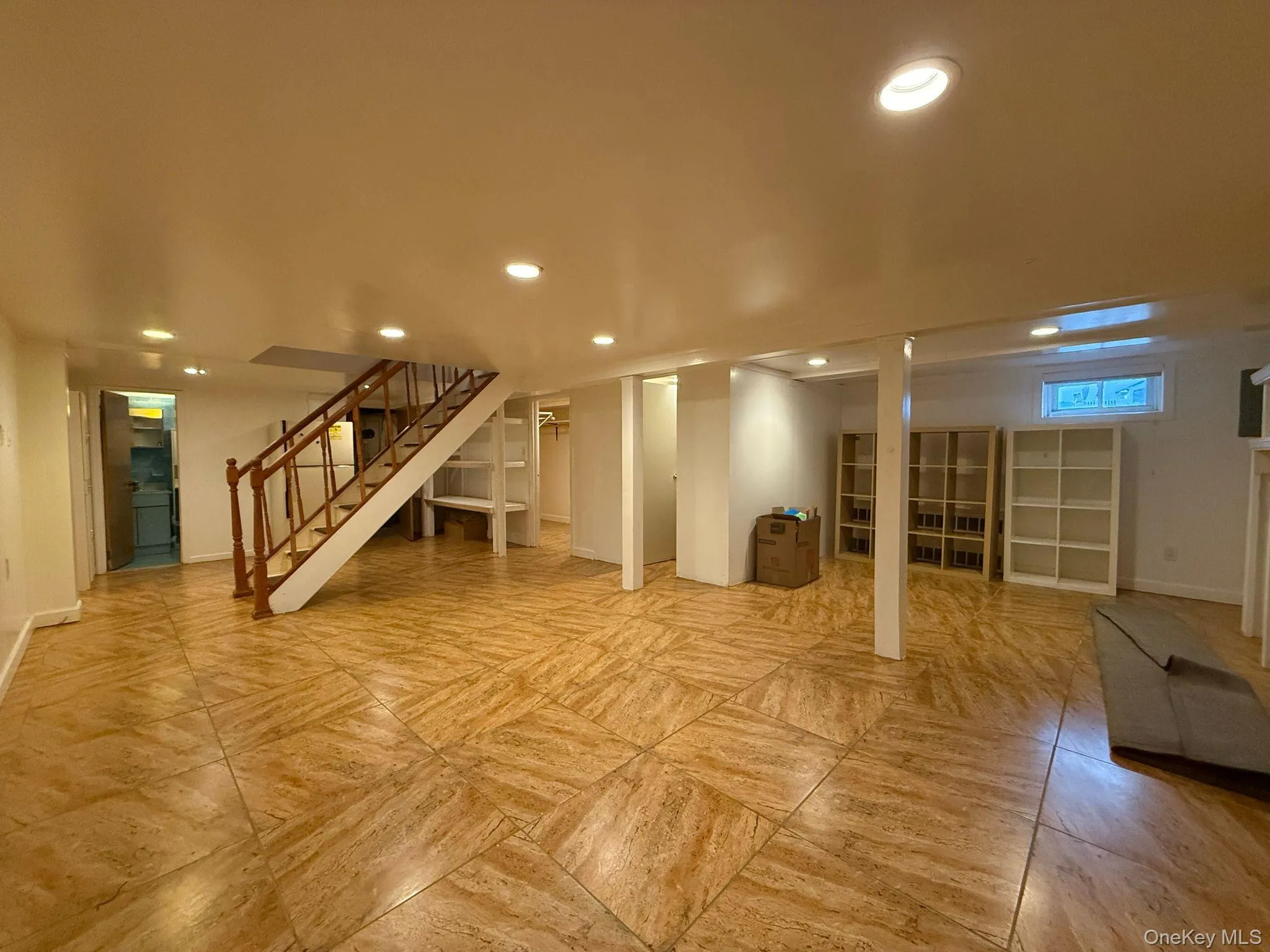 Basement featuring baseboards, stairs, and recessed lighting Basement featuring baseboards, stairs, and recessed lighting