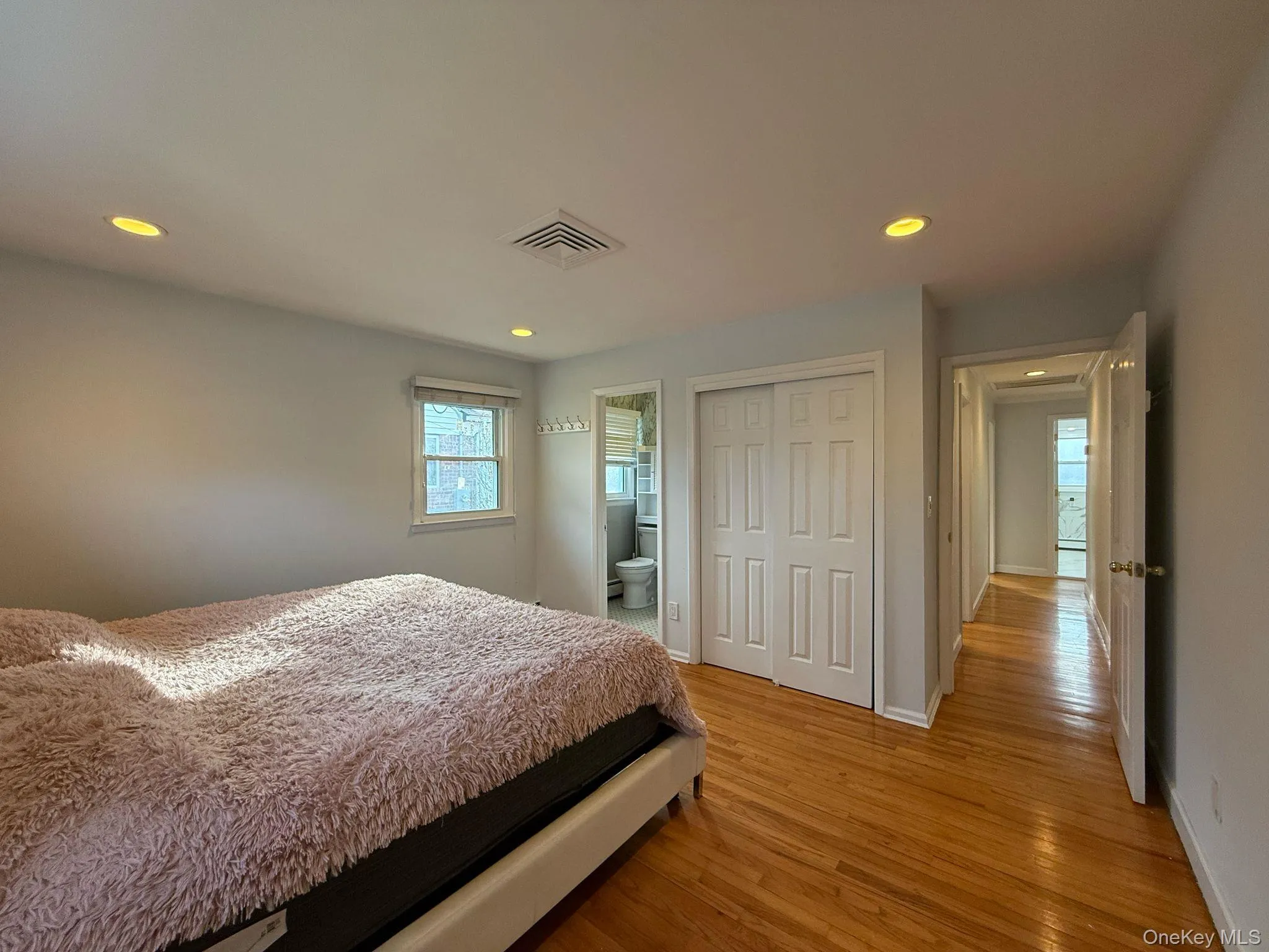 Bedroom with baseboards, visible vents, recessed lighting, and light wood-type flooring Bedroom with baseboards, visible vents, recessed lighting, and light wood-type flooring