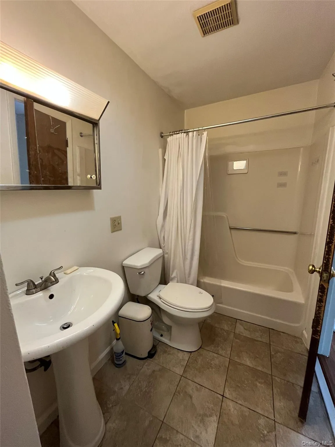 Full bath with shower / bath combo and tile patterned flooring Full bath with shower / bath combo and tile patterned flooring
