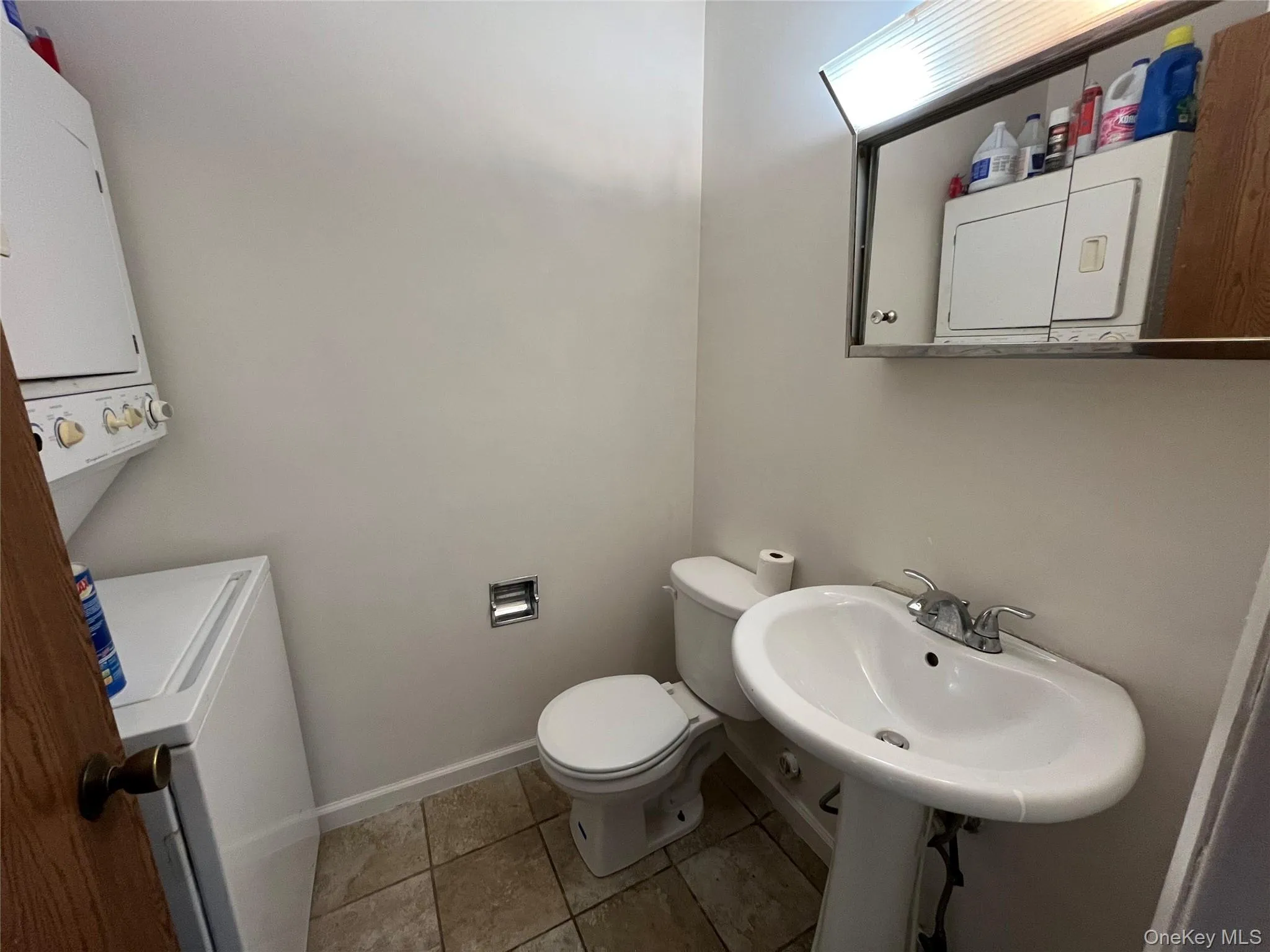Bathroom featuring toilet and tile patterned flooring Bathroom featuring toilet and tile patterned flooring
