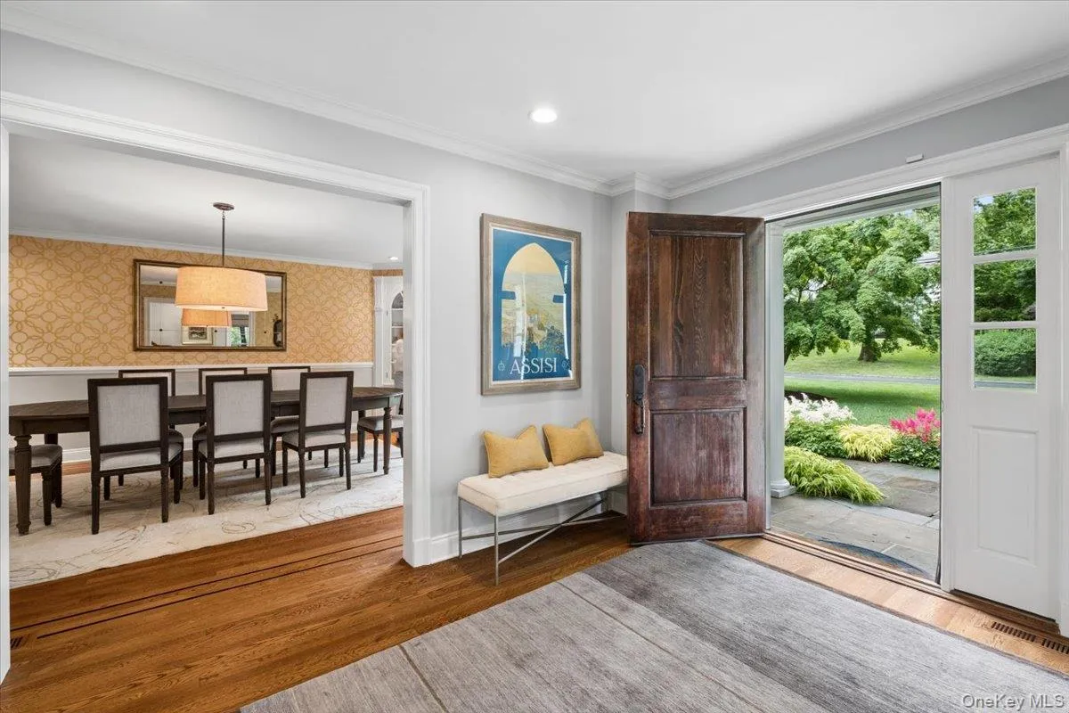 Hardwood flooring entry with a rustic wood door and glass-paneled sidelight Hardwood flooring entry with a rustic wood door and glass-paneled sidelight