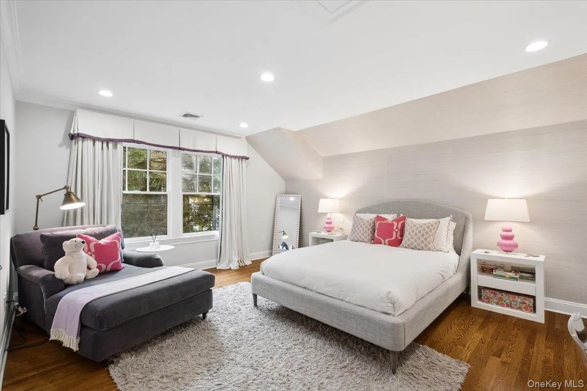 Hardwood flooring complementing light-colored walls in this lovely bedroom Hardwood flooring complementing light-colored walls in this lovely bedroom
