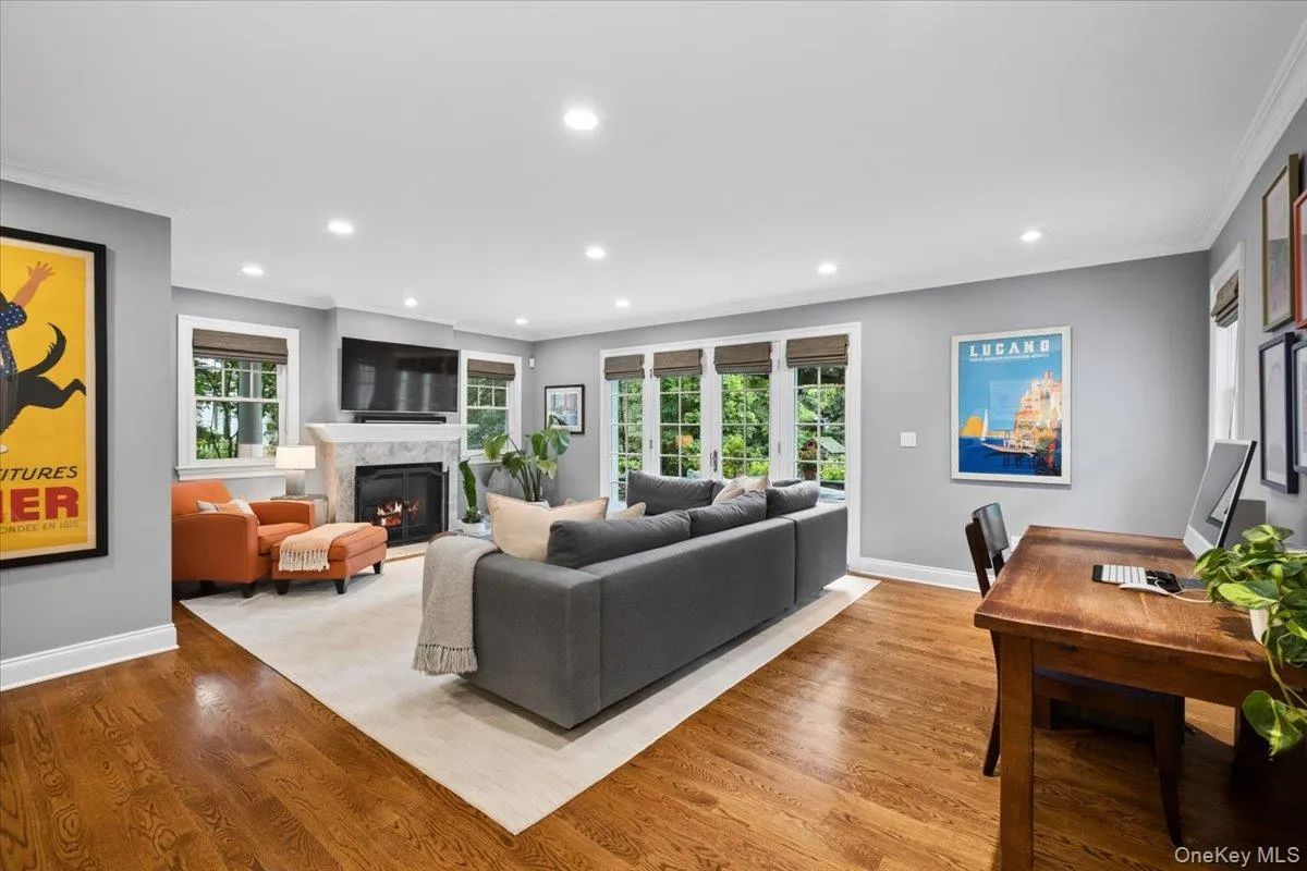 Spacious family room featuring rich wood-finish flooring, recessed lighting and french doors leading out the outdoor space perfect for relaxing or entertaining Spacious family room featuring rich wood-finish flooring, recessed lighting and french doors leading out the outdoor space perfect for relaxing or entertaining