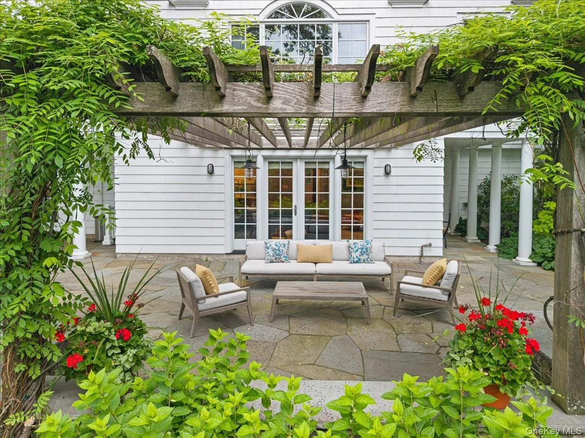 The perfect spot on the patio for entertaining or just relaxing on the stone patio featuring the overhead pergola The perfect spot on the patio for entertaining or just relaxing on the stone patio featuring the overhead pergola