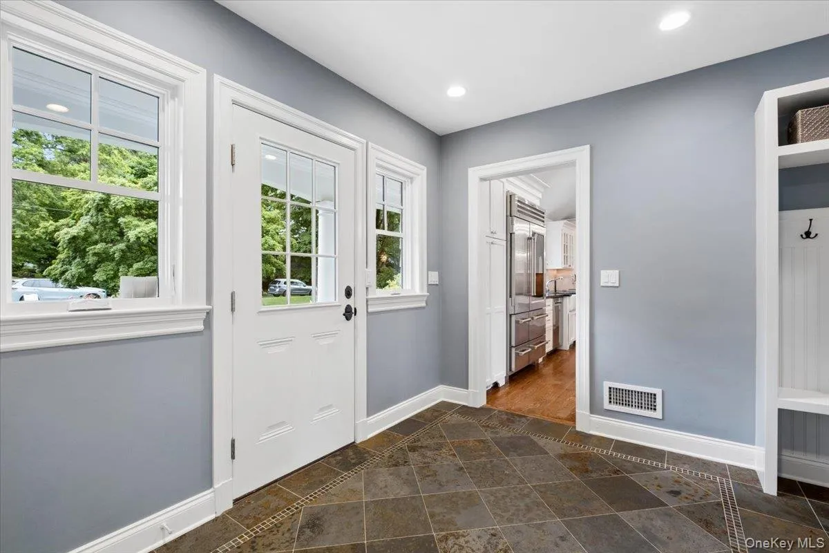 The front/side door affords easy access in/out of the mudroom The front/side door affords easy access in/out of the mudroom