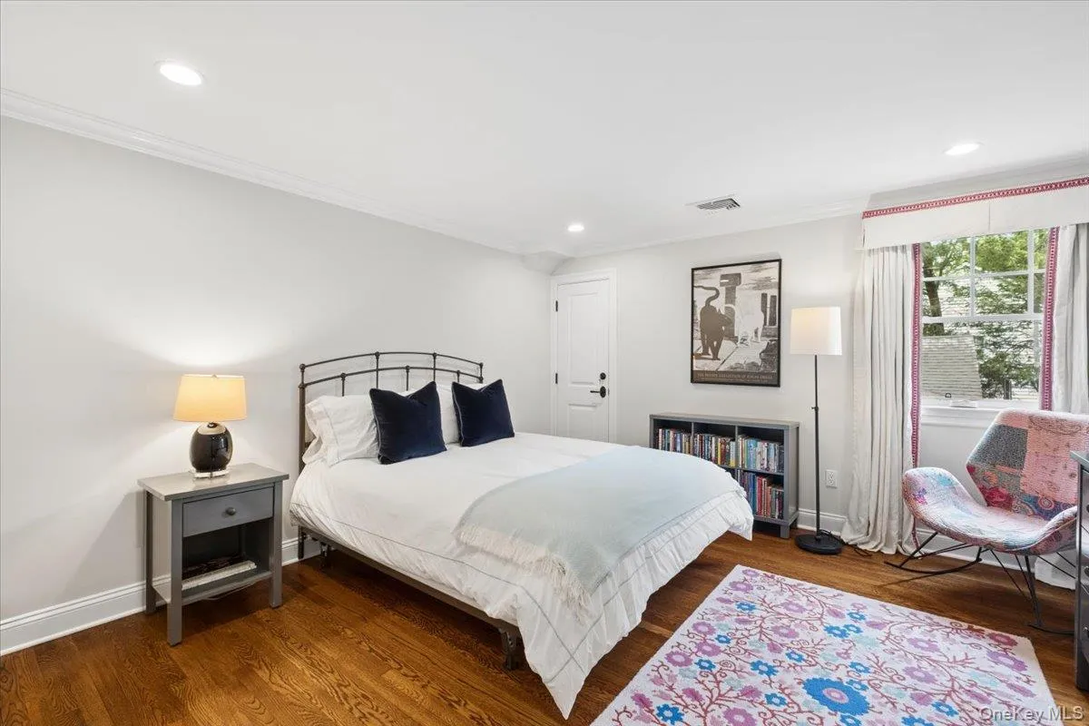 Hardwood flooring complements the neutral wall tones and white trim in this sunlit bedroom Hardwood flooring complements the neutral wall tones and white trim in this sunlit bedroom