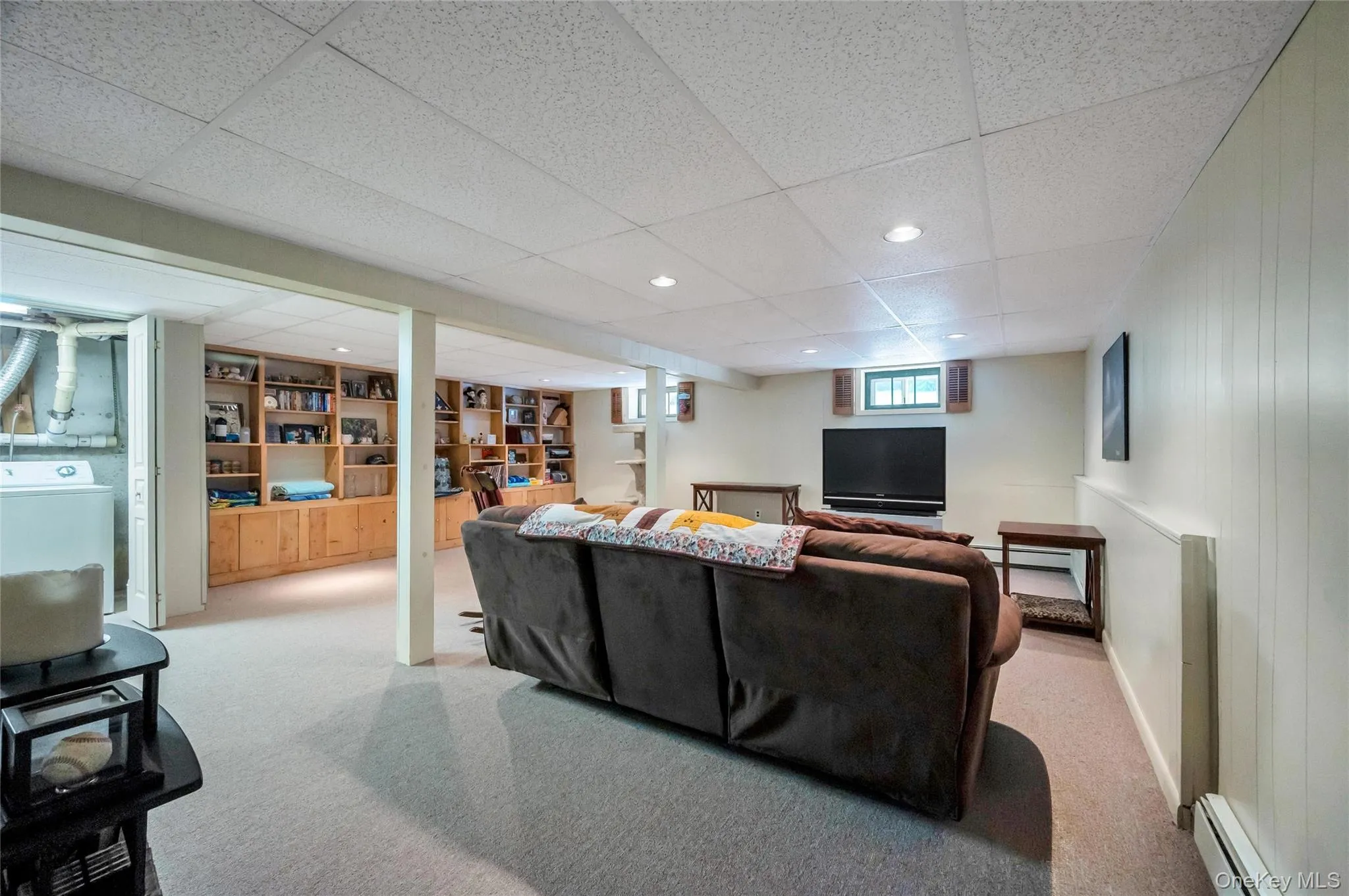 Lower level featuring wood-finish built-in shelving, recessed lighting, and wall-to-wall carpeting Lower level featuring wood-finish built-in shelving, recessed lighting, and wall-to-wall carpeting