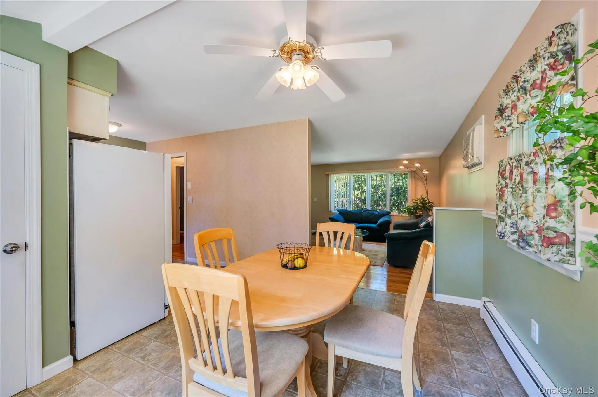 Kitchen dining area featuring tiled flooring and a ceiling fan Kitchen dining area featuring tiled flooring and a ceiling fan