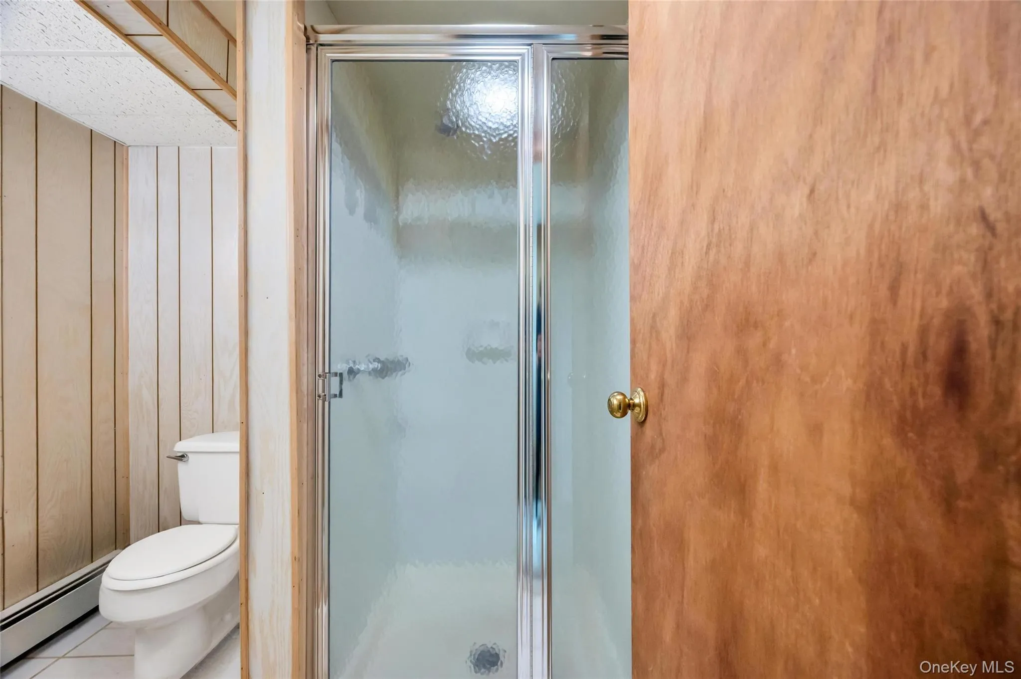 Bathroom featuring toilet and shower Bathroom featuring toilet and shower