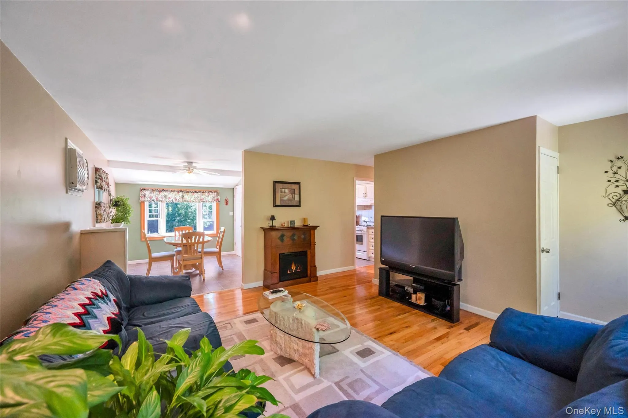 Hardwood flooring extends throughout this open-concept living area Hardwood flooring extends throughout this open-concept living area