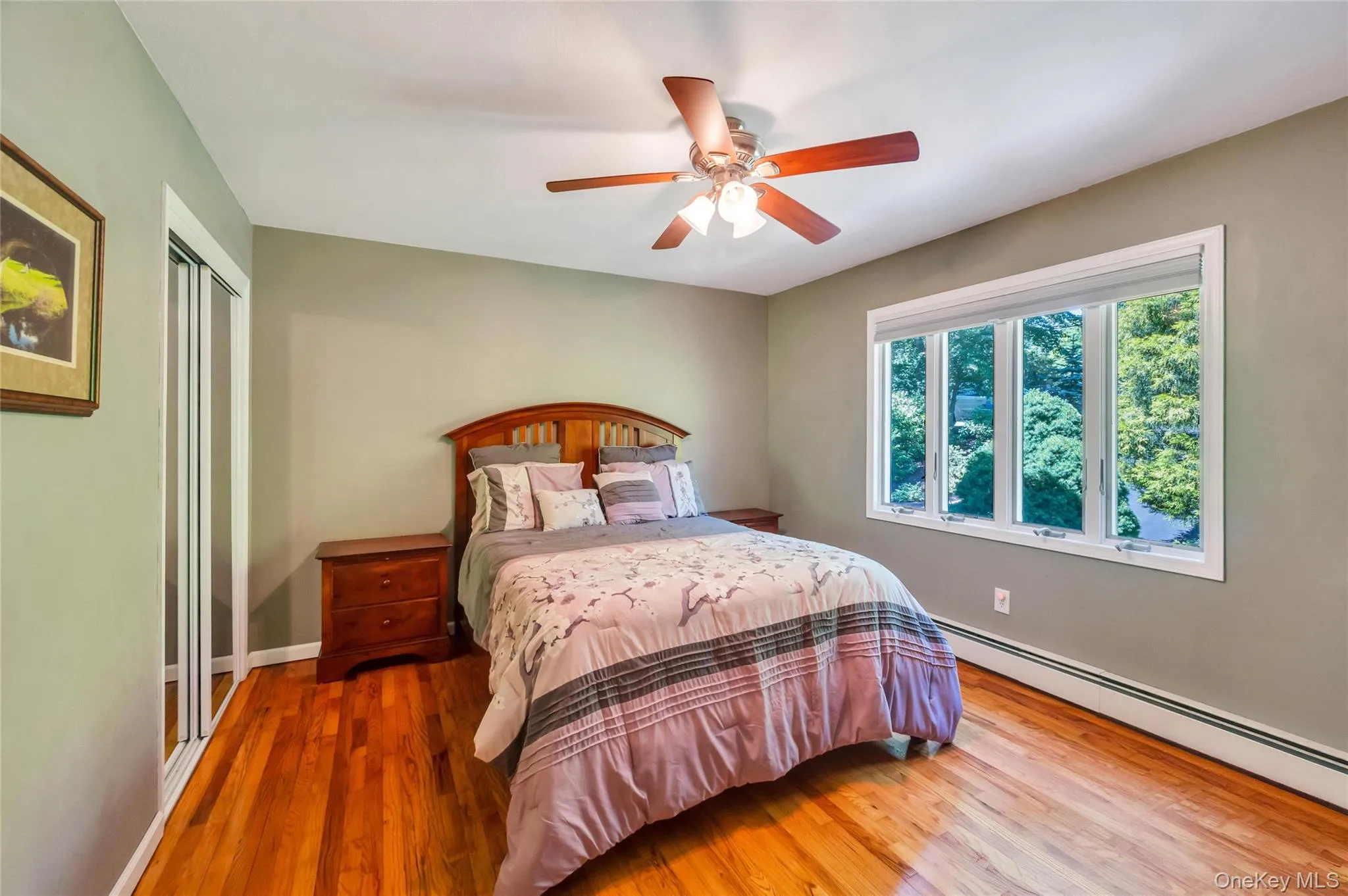 Room featuring hardwood flooring and a ceiling fan with integrated lighting Room featuring hardwood flooring and a ceiling fan with integrated lighting