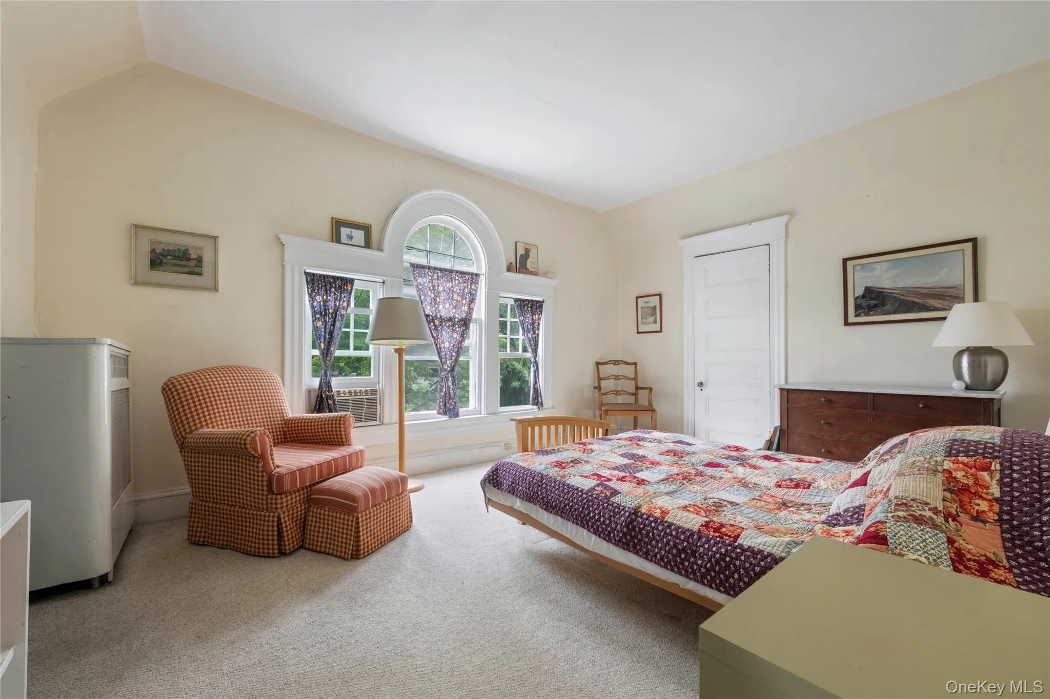 Arch-top window assembly with multiple panes, featuring white trim and a window air conditioning unit Arch-top window assembly with multiple panes, featuring white trim and a window air conditioning unit