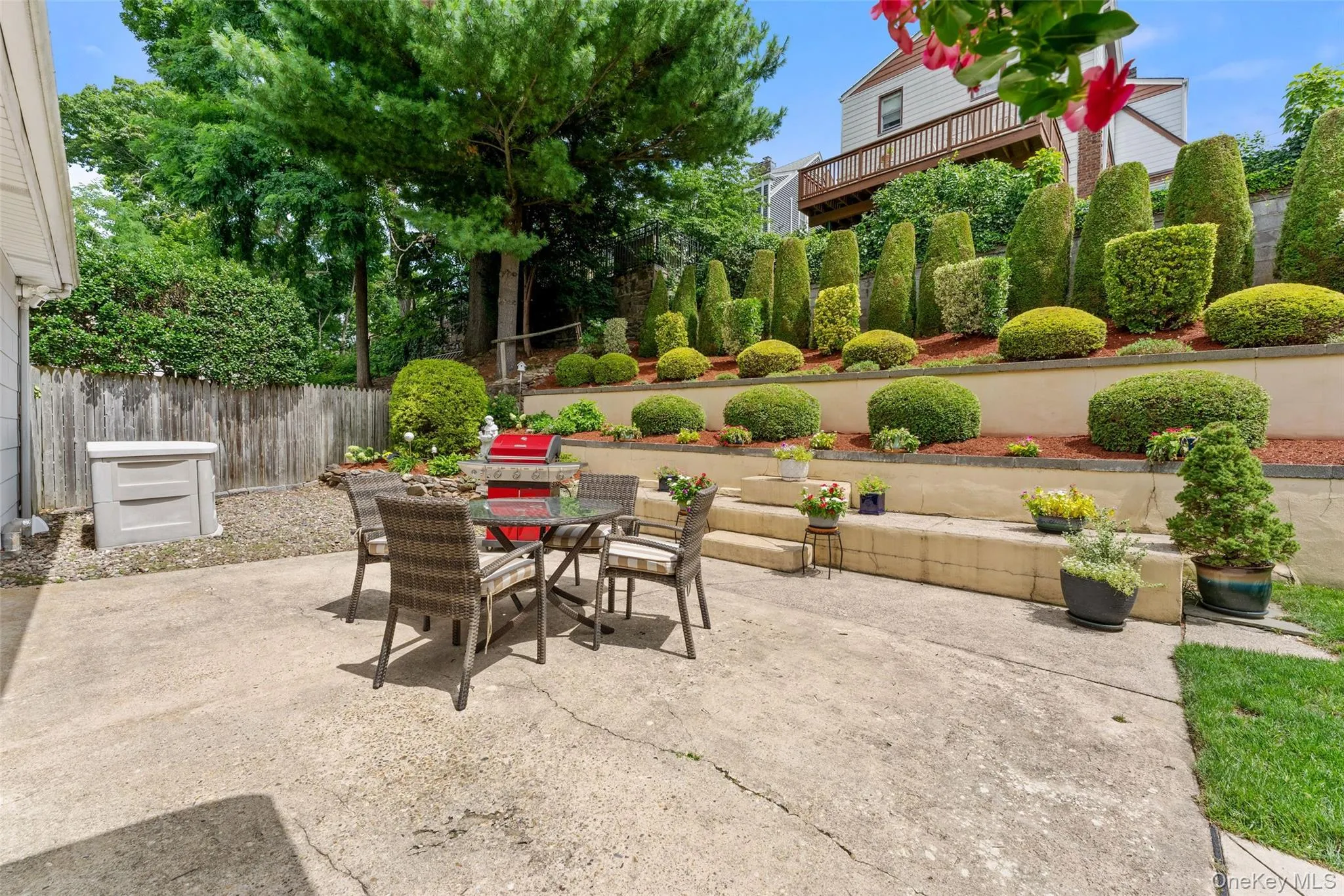 The great outdoors featuring an expansive patio and beautifully landscaped garden. The great outdoors featuring an expansive patio and beautifully landscaped garden.