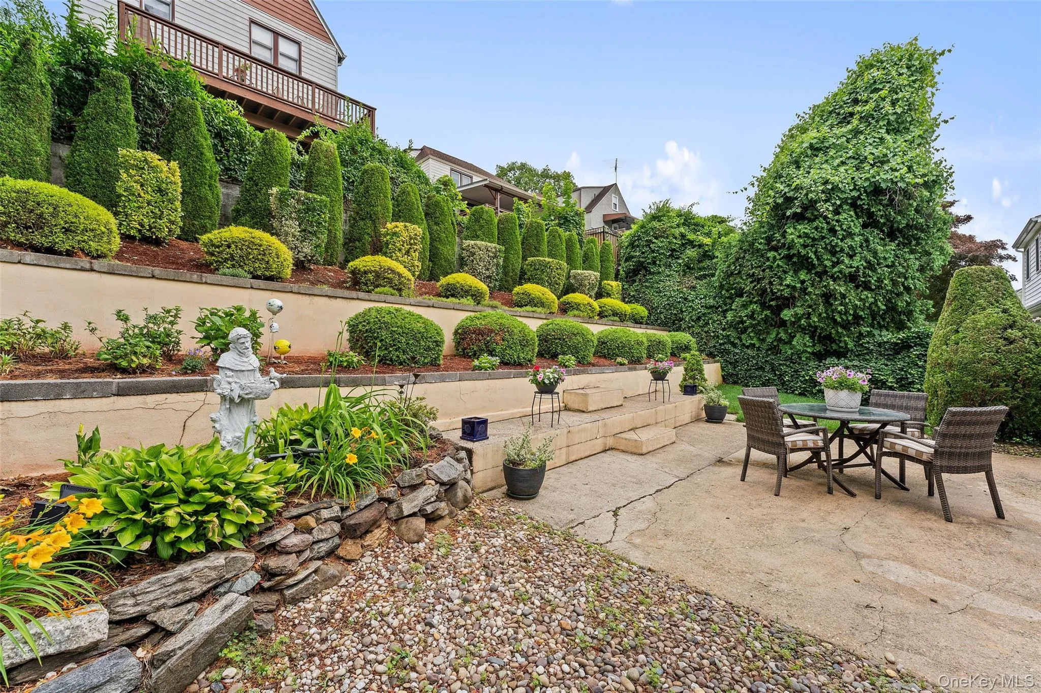 View of the mature perennial plantings and trees. View of the mature perennial plantings and trees.