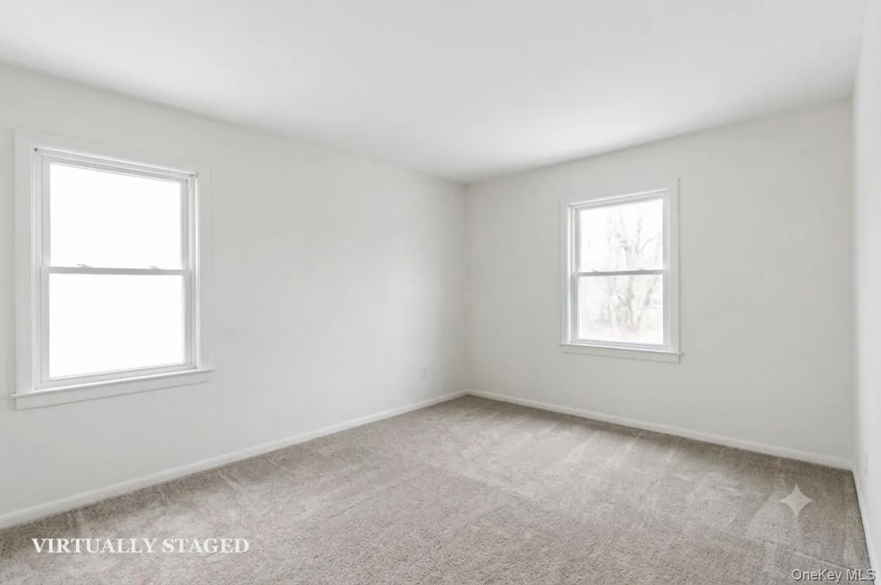 Bedroom 2 - virtually staged to show empty with new carpeting Bedroom 2 - virtually staged to show empty with new carpeting