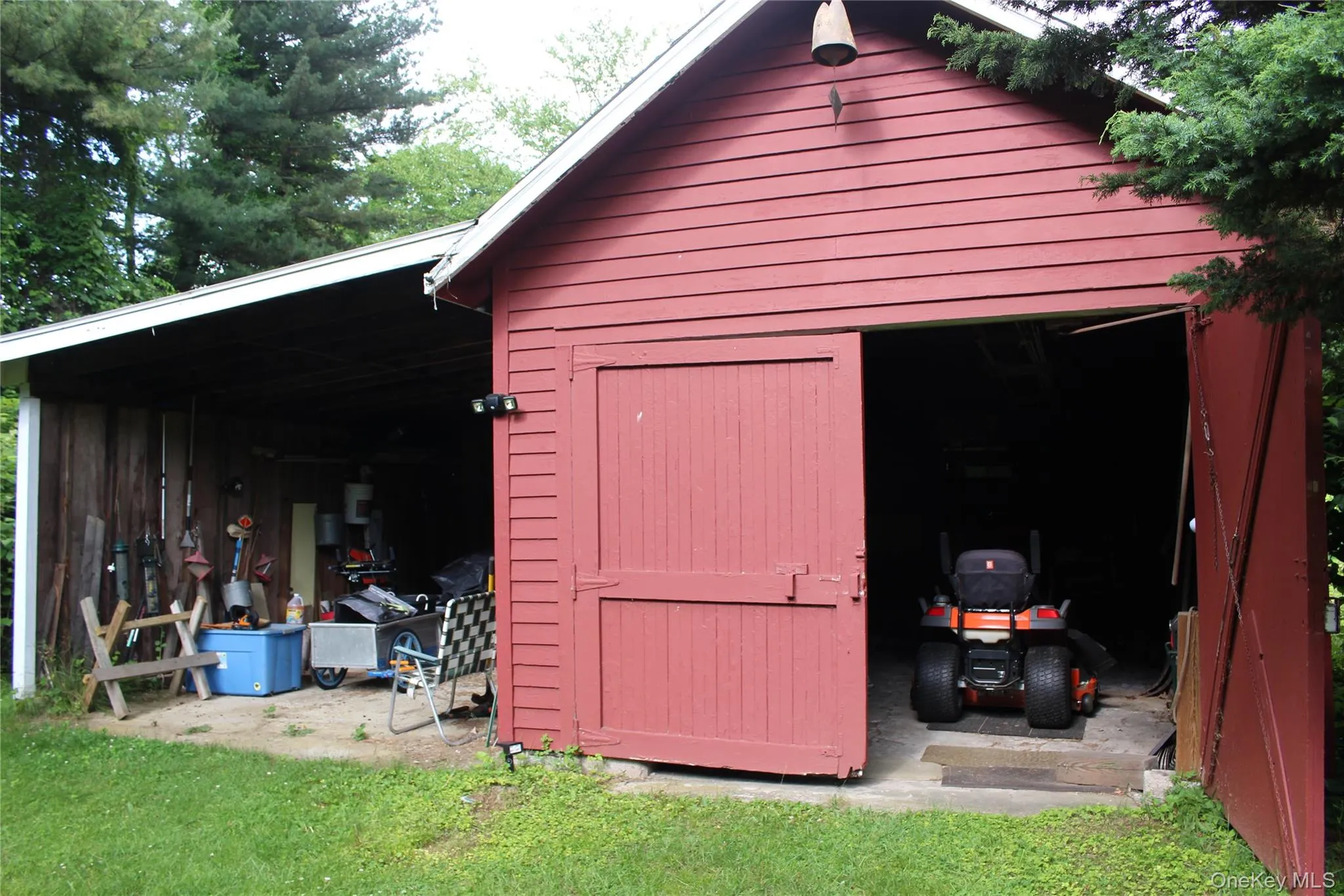 Red barn structure with horizontal siding and a white trim roofline Red barn structure with horizontal siding and a white trim roofline