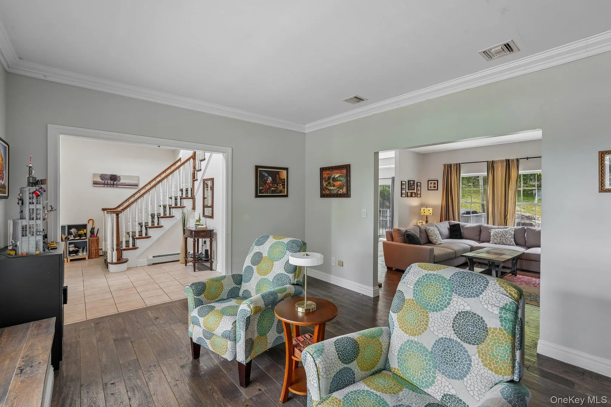 Living room with entrance hallway to left and family room in rear Living room with entrance hallway to left and family room in rear