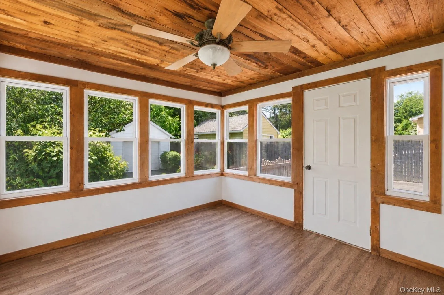 4 Season room with wood ceiling, covered in windows showcasing the backyard 4 Season room with wood ceiling, covered in windows showcasing the backyard